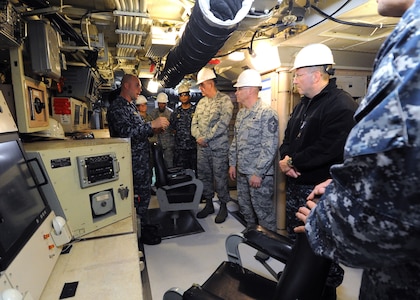 U.S. Air Force Gen. John E. Hyten (center), commander of U.S. Strategic Command (USSTRATCOM) receives a brief on how the U.S. Submarine Force supports USSTRATCOM mission requirements at Naval Air Station Norfolk, Va. Hyten is visiting submarine forces, his first as commander of USSTRATCOM, to see the operations of one leg of the nuclear triad. One of nine DoD unified combatant commands, USSTRATCOM has global strategic missions assigned through the Unified Command Plan that include strategic deterrence; space operations; cyberspace operations; joint electronic warfare; global strike; missile defense; intelligence, surveillance and reconnaissance; and analysis and targeting.