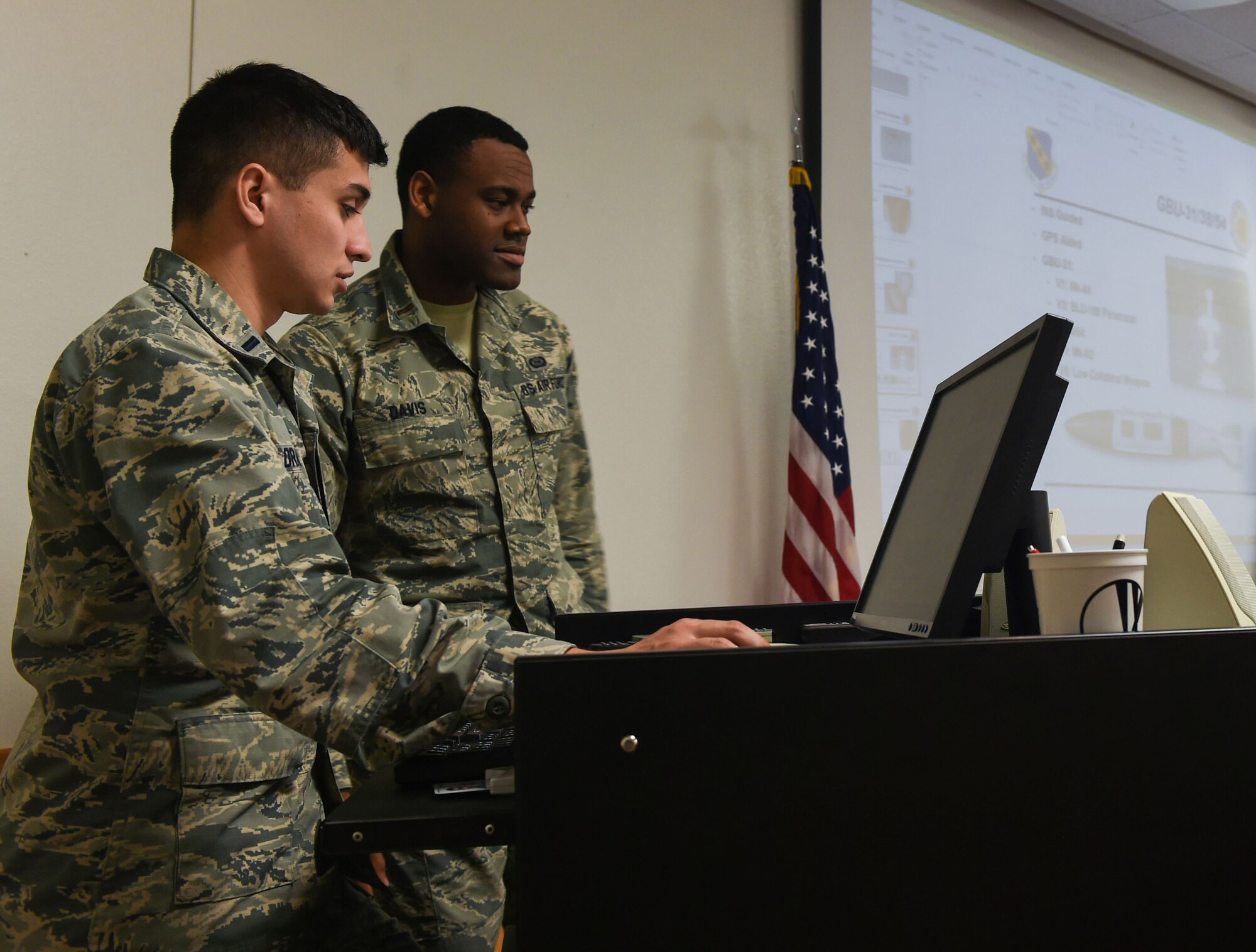 U.S. Air Force 1st Lt. Matthew Drake (left) and 2nd Lt. Myles Davis, 7th Operations Support Squadron intelligence officers, review slides with information on the B-1B Lancer at Dyess Air Force Base, Texas, Jan. 25, 2017. During the final stages of mission qualification, Drake and Davis work with a team of pilots, weapon system operators and other intelligence professionals to create a mission plan as part of their capstone.  Intel Airmen analyze information, coordinate with other units and are expected to know not only the vulnerabilities of an enemy, but also their proficiencies and potential threats to national security. (U.S. Air Force photo by Airman 1st Class Quay Drawdy)