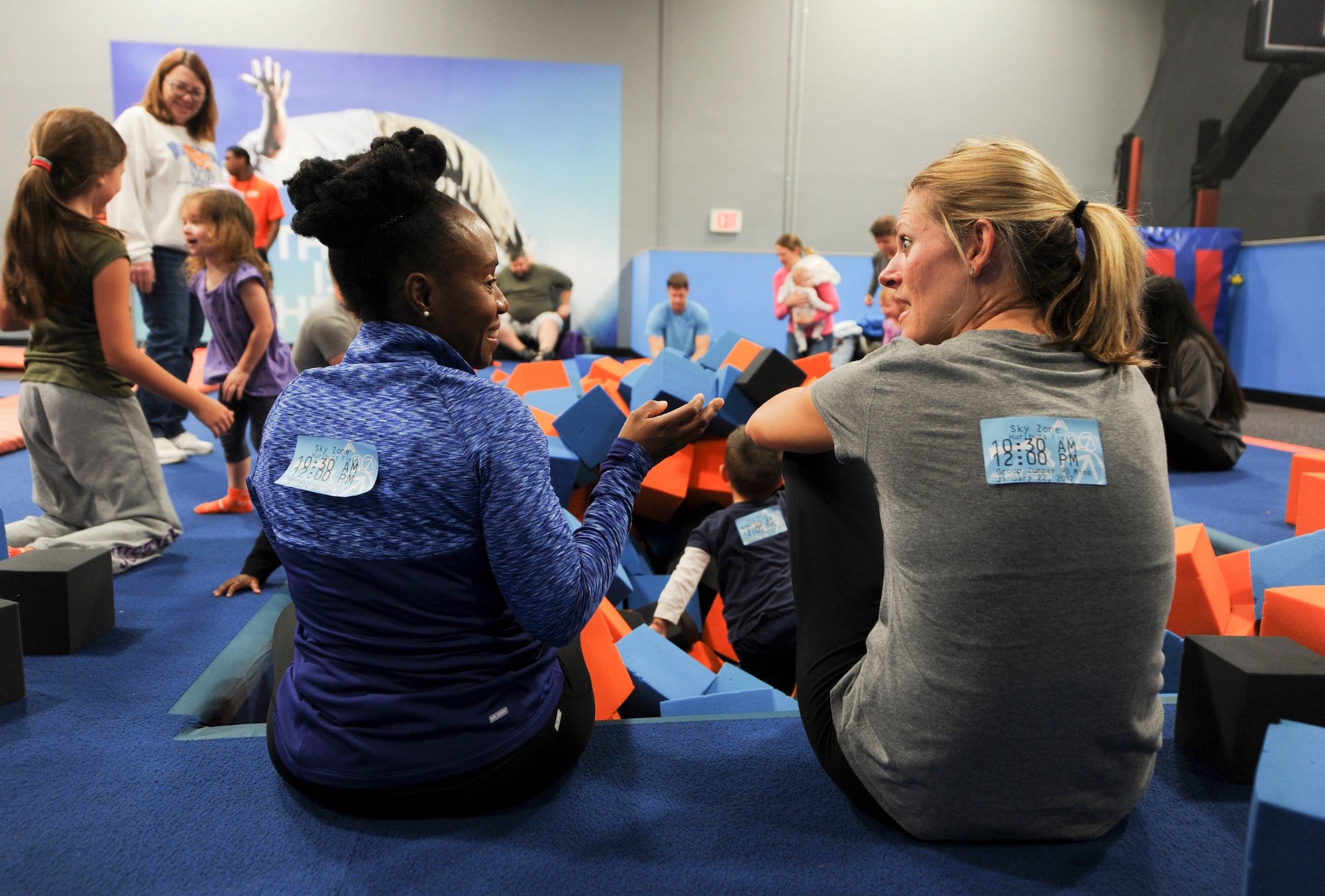 Spouses of deployed Air Commandos mingle during a Hearts Apart event while their children play at the Sky Zone in Pensacola, Fla., Jan. 28, 2017. Hearts Apart offers support to spouses and loved ones of deployed service members through activities, outings, monthly newsletters and other resources. (U.S. Air Force photo by Senior Airman Kasie P. Whitfield)