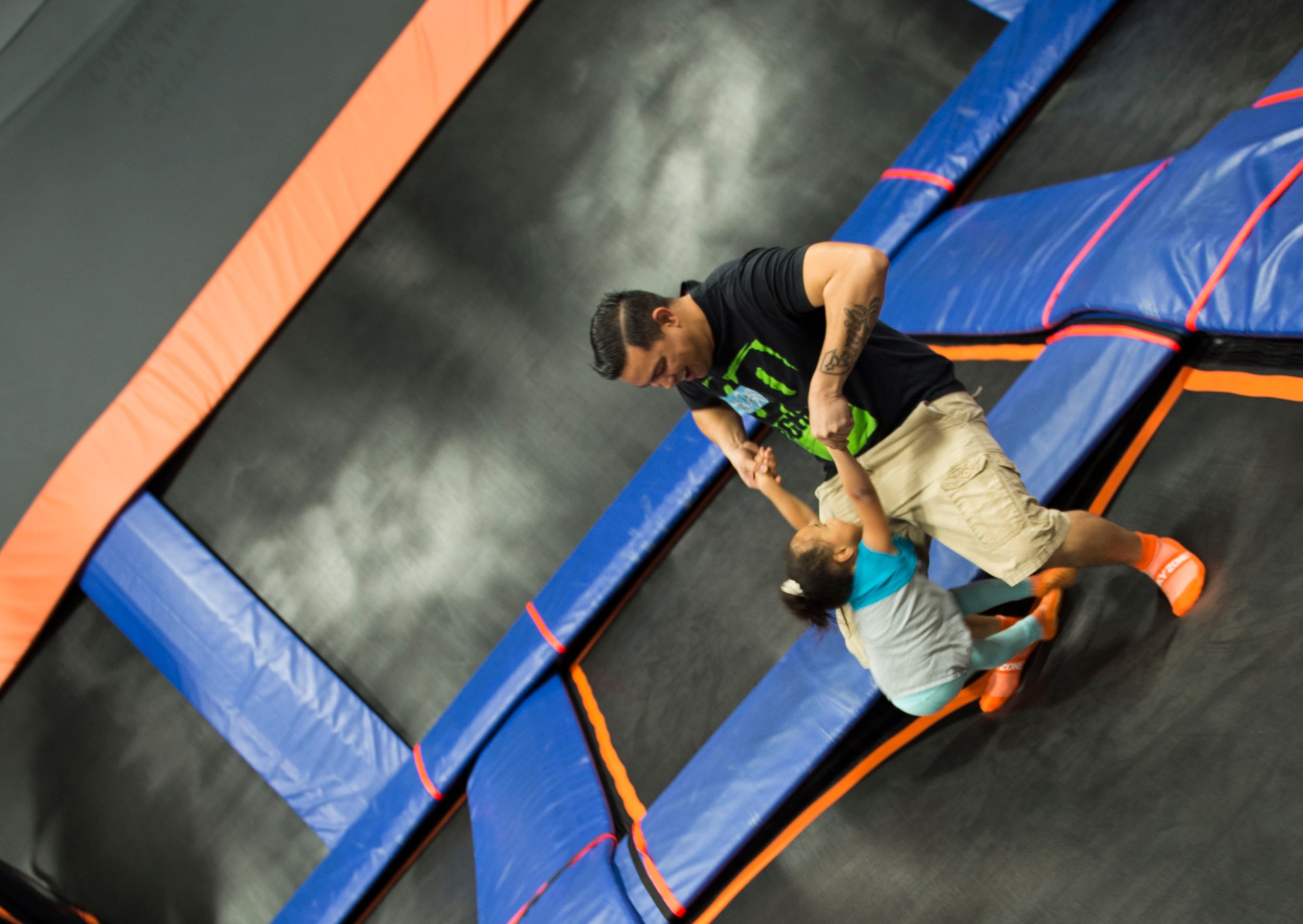 Staff Sgt. Patrick Rochester, a weapons load crew chief with the 1st Special Operations Maintenance Squadron, plays with his daughter, Aliyna Rochester, during a Hearts Apart event at the Sky Zone in Pensacola, Fla., Jan. 28, 2017. Hearts Apart is a program through the Hurlburt Field Airman and Family Readiness Center that connects spouses and loved ones of deployed Air Commandos to foster support systems. (U.S. Air Force photo by Senior Airman Krystal M. Garrett)