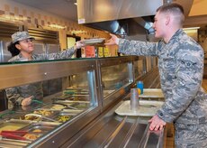 Airman 1st Class Ashley Gonzalez, 628th Force Support Squadron food service apprentice, serves a plate of beef stir fry to an Airman at the Robert D. Gaylor Dining Facility here, Jan. 31, 2017. The dining facility will closed for repairs March 1. Airmen on meal cards will receive a basic allowance for subsistence during the 10-month project.