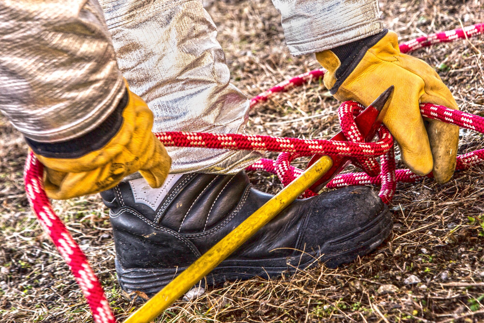 Firefighters with the 375th Civil Engineer Squadron perform drills during a timed test at Scott on Jan. 21. The test explored standards and applied principles of the standards as participants were timed on dragging the hose, putting their gear on and hoisting a hatchet among other smaller drills. Firefighters deal with everything from brush fires to burning rocket fuel and hazardous material fires. Throughout the year the firefighters train on fire suppression, aviation fire suppression, hazardous materials, emergency medical services, technical rescue, fire prevention and public education, as well as adequate standard operating guides, effective program management of additional duties and a comprehensive career training program.