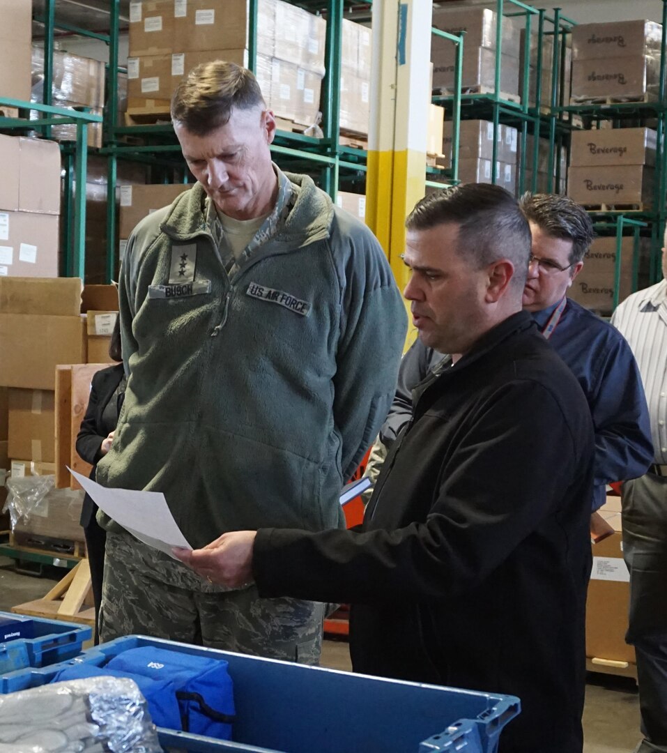 Joseph Sousa, Bulk Distribution Division chief, is showing tDLA director Air Force Lt. Gen. Andy Busch materiel associated with the Wildland Fire Mission during his visit to DLA Distribution San Joaquin. 
