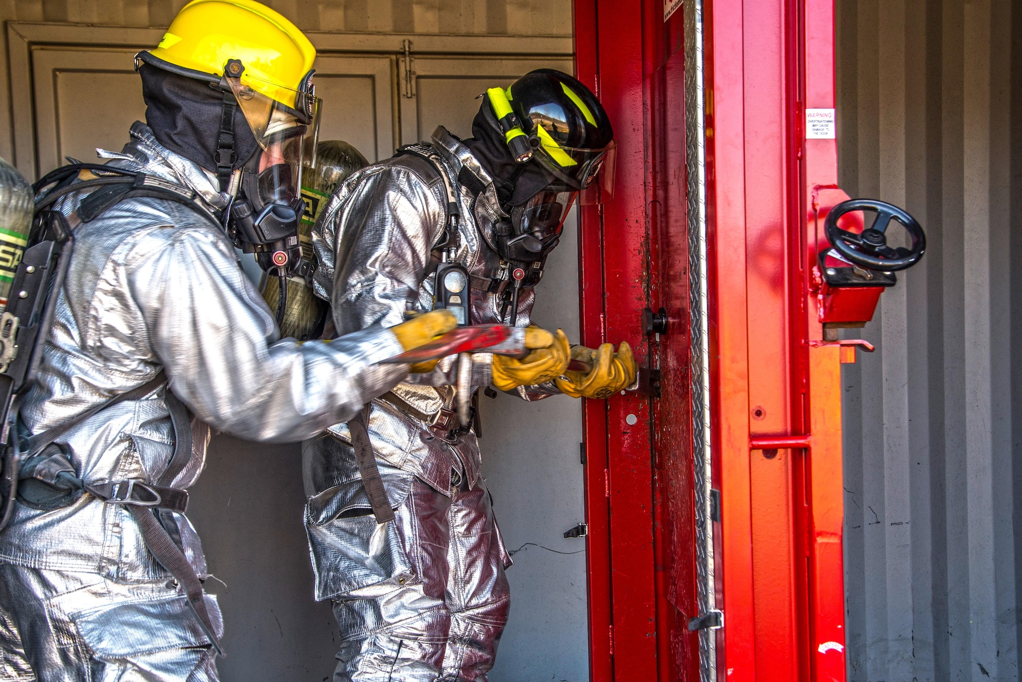 Firefighters with the 375th Civil Engineer Squadron perform drills during a timed test at Scott on Jan. 21. The test explored standards and applied principles of the standards as participants were timed on dragging the hose, putting their gear on and hoisting a hatchet among other smaller drills. Firefighters deal with everything from brush fires to burning rocket fuel and hazardous material fires. Throughout the year the firefighters train on fire suppression, aviation fire suppression, hazardous materials, emergency medical services, technical rescue, fire prevention and public education, as well as adequate standard operating guides, effective program management of additional duties and a comprehensive career training program.