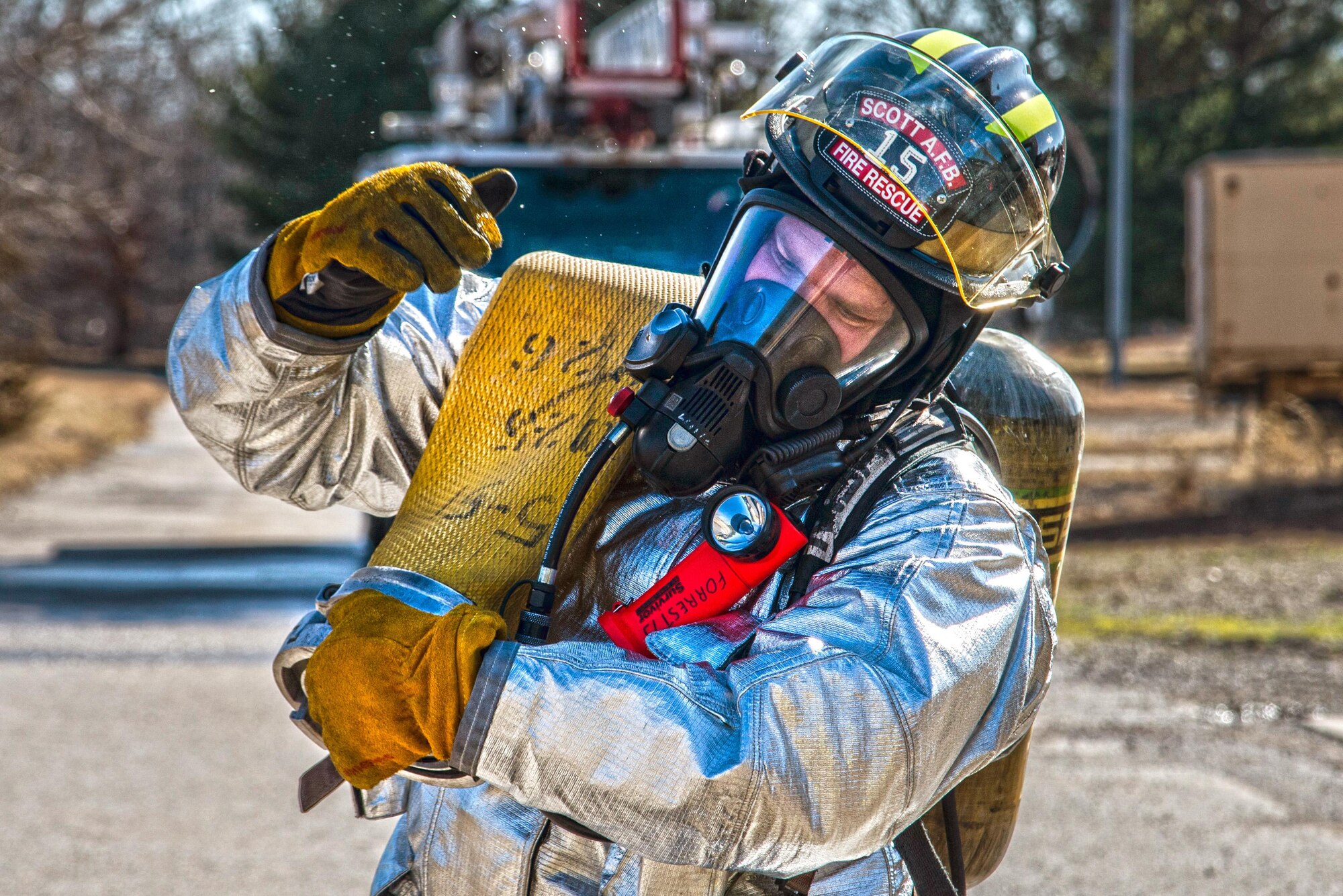 Firefighters with the 375th Civil Engineer Squadron perform drills during a timed test at Scott on Jan. 21. The test explored standards and applied principles of the standards as participants were timed on dragging the hose, putting their gear on and hoisting a hatchet among other smaller drills. Firefighters deal with everything from brush fires to burning rocket fuel and hazardous material fires. Throughout the year the firefighters train on fire suppression, aviation fire suppression, hazardous materials, emergency medical services, technical rescue, fire prevention and public education, as well as adequate standard operating guides, effective program management of additional duties and a comprehensive career training program.