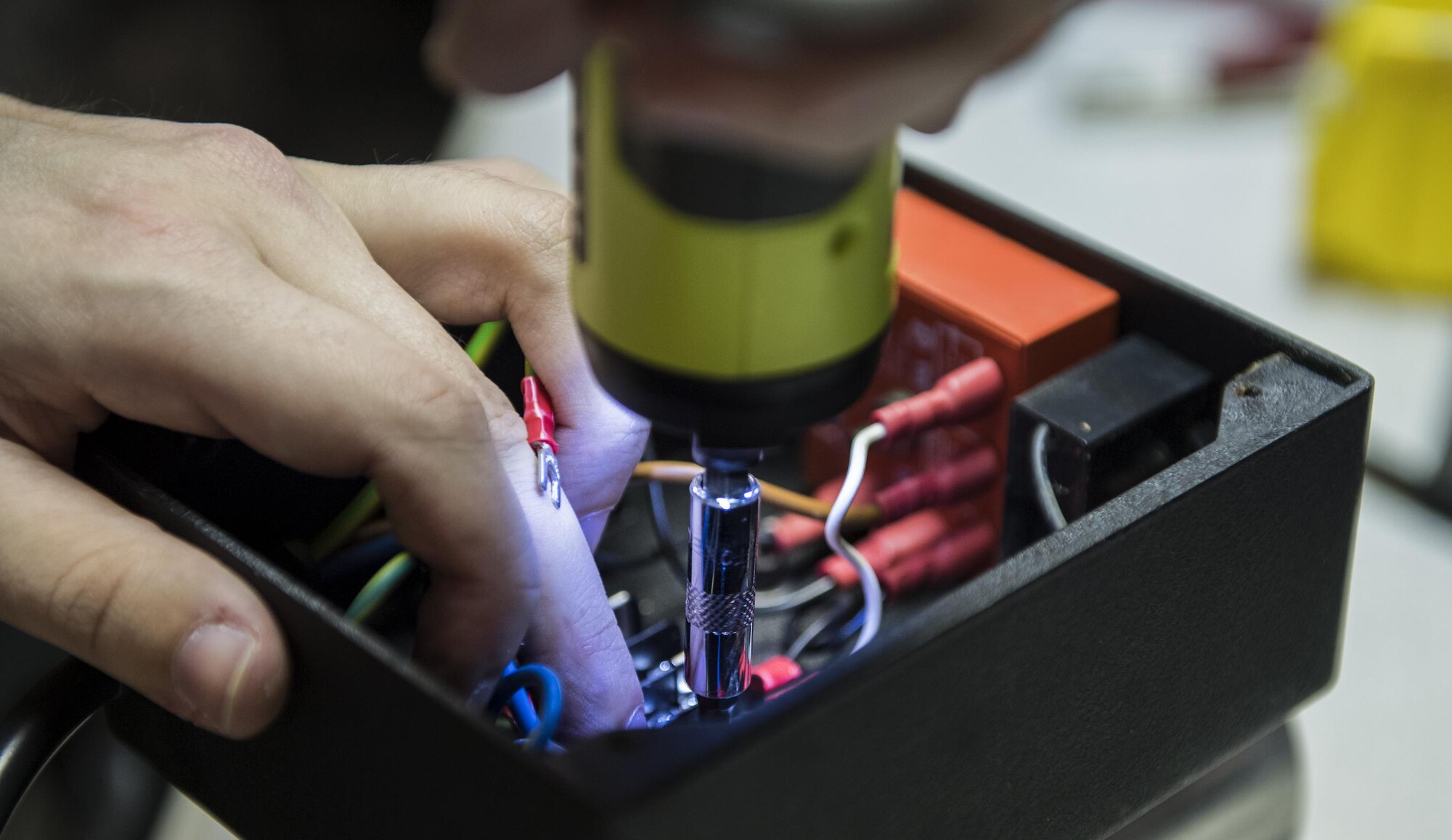 Staff Sgt. Cody Voelker, 23d Maintenance Group Air Force Repair Enhancement Program Technician, removes screws from a box, Jan. 30, 2017, at Moody Air Force Base, Ga. The box houses the wiring components that power a metal rod sharpener. (U.S. Air Force photo by Airman 1st Class Janiqua P. Robinson)