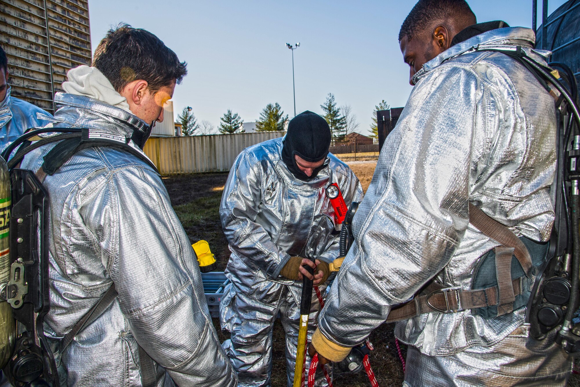 Firefighters with the 375th Civil Engineer Squadron perform drills during a timed test at Scott on Jan. 21. The test explored standards and applied principles of the standards as participants were timed on dragging the hose, putting their gear on and hoisting a hatchet among other smaller drills. Firefighters deal with everything from brush fires to burning rocket fuel and hazardous material fires. Throughout the year the firefighters train on fire suppression, aviation fire suppression, hazardous materials, emergency medical services, technical rescue, fire prevention and public education, as well as adequate standard operating guides, effective program management of additional duties and a comprehensive career training program.