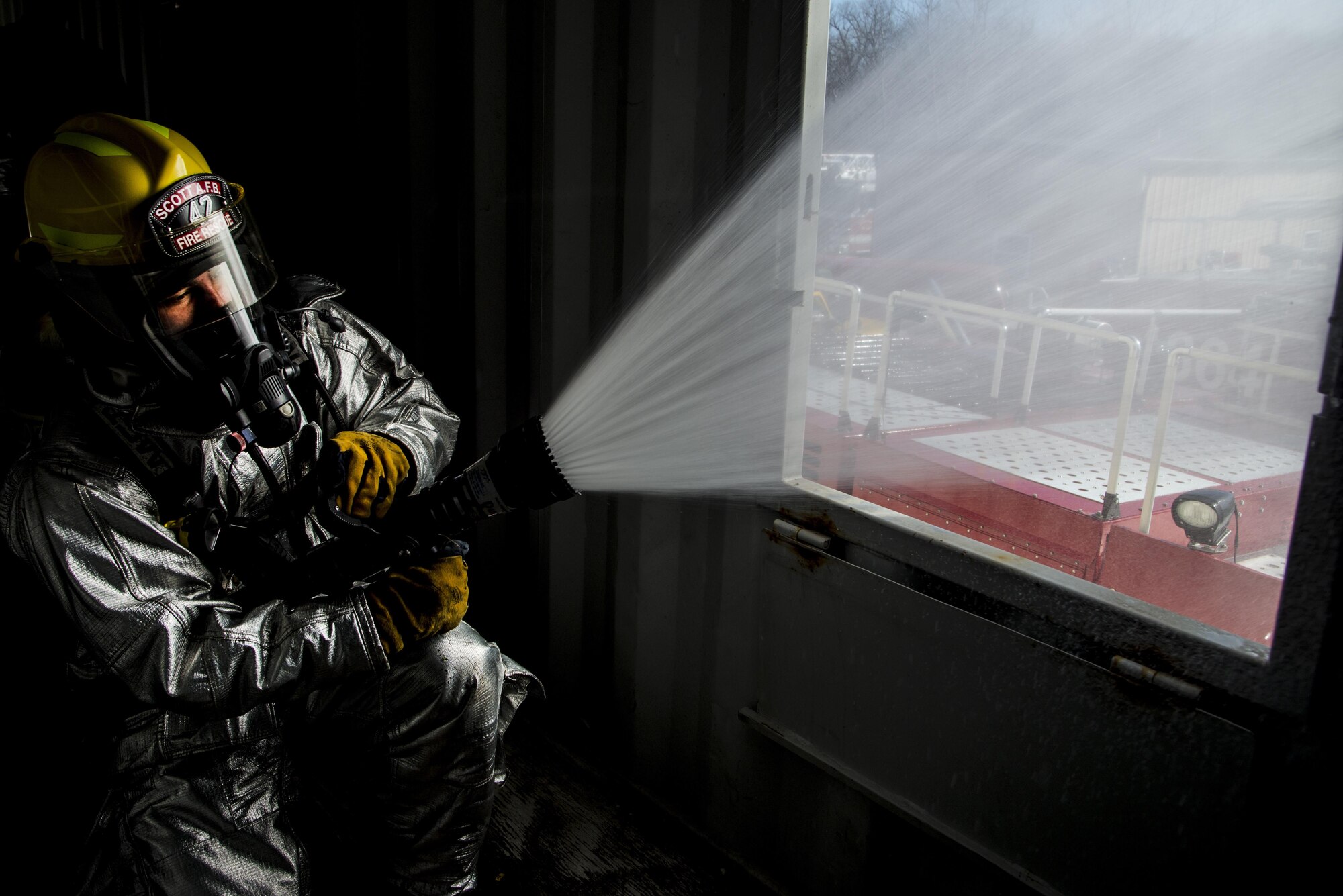 Firefighters with the 375th Civil Engineer Squadron perform drills during a timed test at Scott on Jan. 21. The test explored standards and applied principles of the standards as participants were timed on dragging the hose, putting their gear on and hoisting a hatchet among other smaller drills. Firefighters deal with everything from brush fires to burning rocket fuel and hazardous material fires. Throughout the year the firefighters train on fire suppression, aviation fire suppression, hazardous materials, emergency medical services, technical rescue, fire prevention and public education, as well as adequate standard operating guides, effective program management of additional duties and a comprehensive career training program.