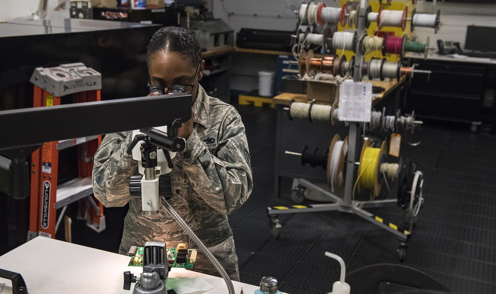 Staff Sgt. Alexandria Jones, 23d Maintenance Group Air Force Repair Enhancement Program technician, looks at microscopic components on a circuit board, Jan. 30, 2017, at Moody Air Force Base, Ga. Moody’s AFREP technicians saved the Air Force $2.4 million during fiscal year 2016 by fixing repairable parts. (U.S. Air Force photo by Airman 1st Class Janiqua P. Robinson)