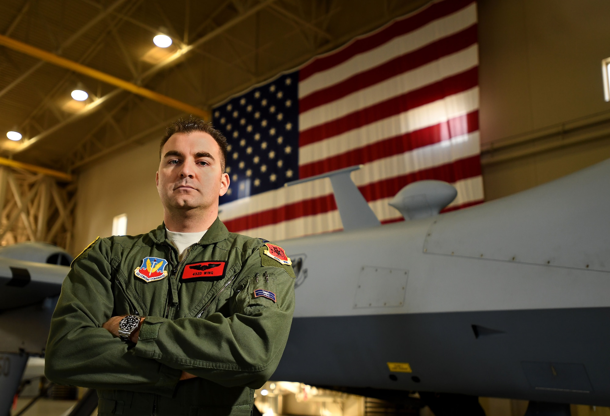 Capt. James, 432nd Wing/432nd Air Expeditionary Wing MQ-9 Reaper and MQ-1 Predator instructor pilot, stands in front of an MQ-9 Jan. 31, 2017, at Creech Air Force Base, Nev. On Aug. 11, 2016, James was off duty when he responded to a vehicular accident by taking initial control of the accident site and administering critical first aid, saving three lives. (U.S. Air Force photo by Airman 1st Class James Thompson)