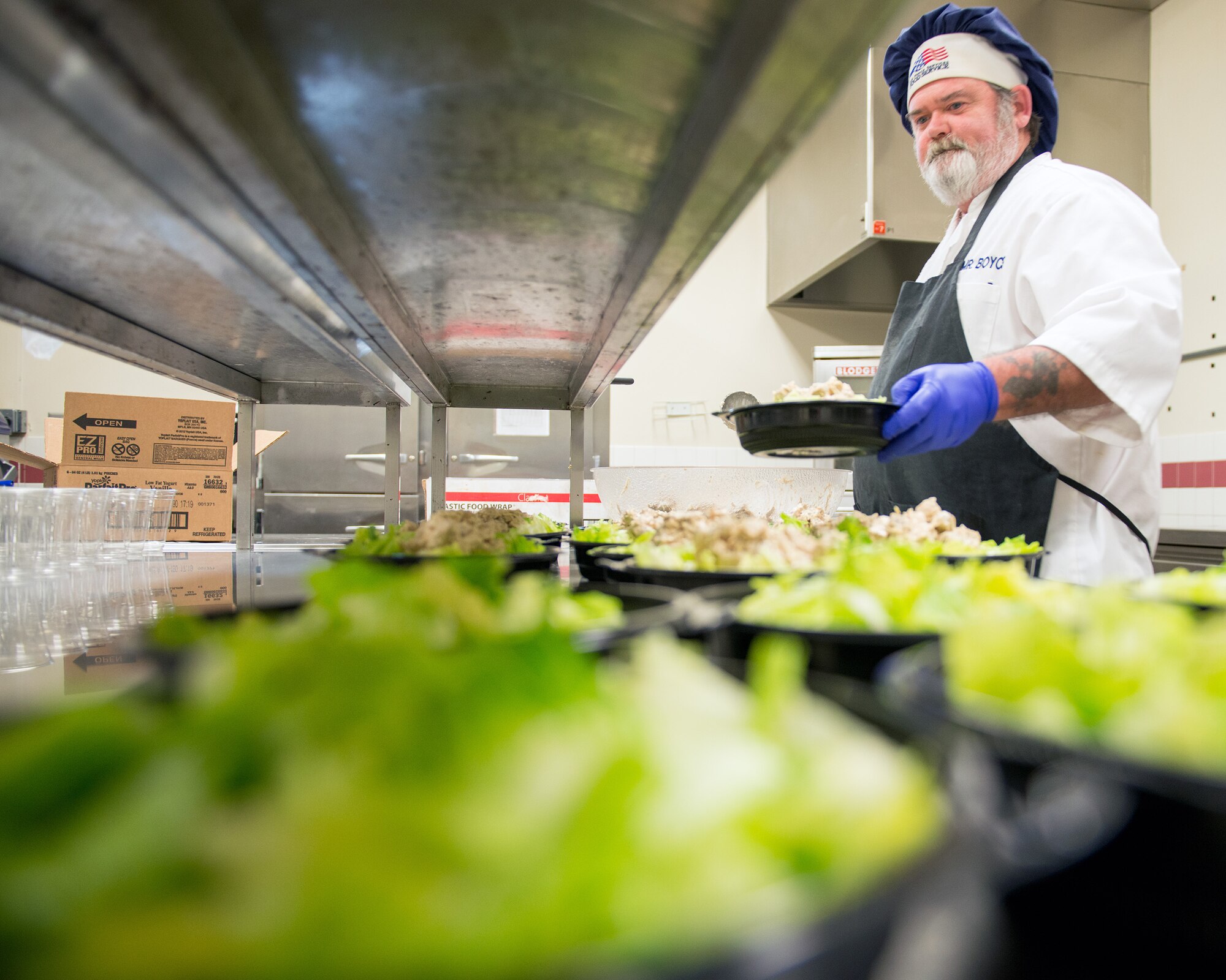 Paul Boyce, 60th Force Support Squadron, prepares salads at the Sierra Inn Dining Facility at Travis Air Force Base, Calif., Jan. 25, 2017. The dining facility was named Air Mobility Command's best and will now compete at the Air Force level for the John L. Hennessy Trophy, which recognizes excellence in food service. (U.S. Air Force photo/Louis Briscese)