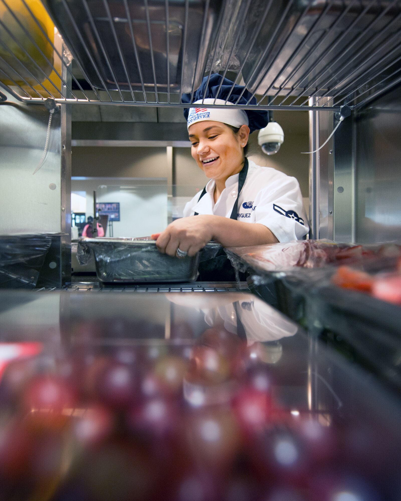 U.S Air Force Airman Eileen Rodriquez-Berumen, 60th Force Support Squadron, retrieves food from a cooler at the Sierra Inn Dining Facility at Travis Air Force Base, Calif., Jan. 25, 2017. The dining facility was named Air Mobility Command's best and will now compete at the Air Force level for the John L. Hennessy Trophy, which recognizes excellence in food service. (U.S. Air Force photo/Louis Briscese)
