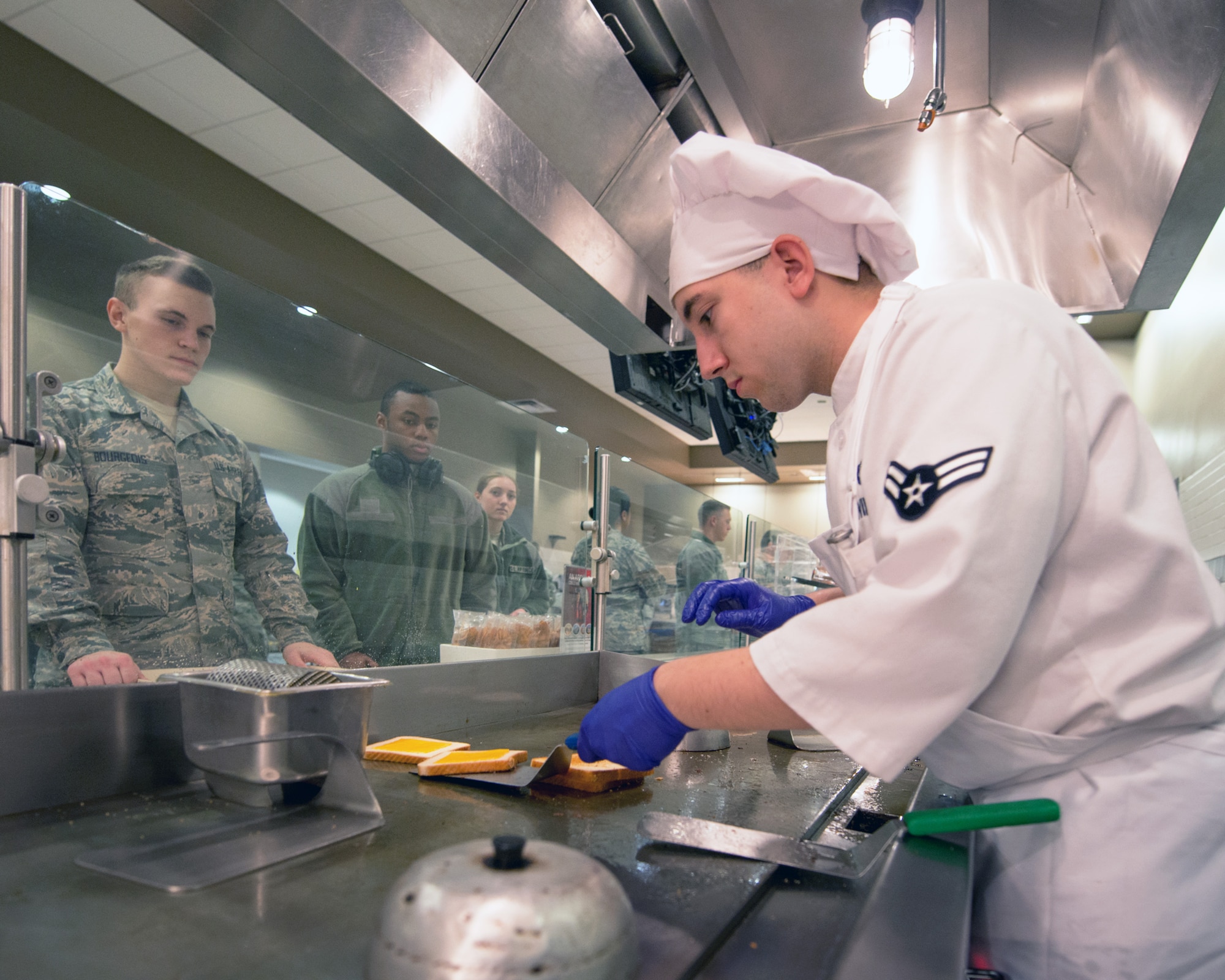 U.S Air Force Airman 1st Class Zachary Wilson, 60th Force Support Squadron, prepares grilled cheese sandwiches during lunch at the Sierra Inn Dining Facility at Travis Air Force Base, Calif., Jan. 25, 2017. The dining facility was named Air Mobility Command's best and will now compete at the Air Force level for the John L. Hennessy Trophy, which recognizes excellence in food service. (U.S. Air Force photo/Louis Briscese)