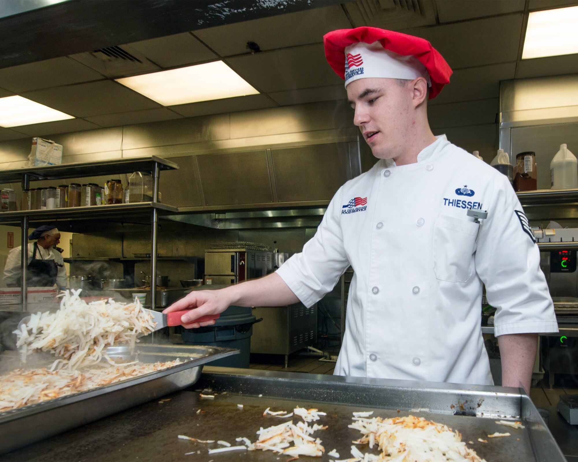 U.S Air Force Staff Sgt. Michael Thiessen, 60th Force Support Squadron, prepares hash browns at the Sierra Inn Dining Facility at Travis Air Force Base, Calif., Jan. 25, 2017. The dining facility was named Air Mobility Command's best and will now compete at the Air Force level for the John L. Hennessy Trophy, which recognizes excellence in food service. (U.S. Air Force photo/Louis Briscese)