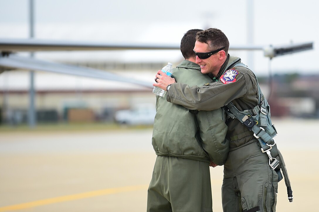 From left, U.S. Air Force Maj. Daniel Dickinson, F-22 Raptor Demonstration Team commander, greats U.S. Air Force Maj. Craig Baker, F-16 Demonstration Team safety officer, after landing at Joint Base Langley-Eustis, Va., Jan. 31, 2017. The F-16 Viper Demo Team traveled to JBLE to perform in front of the Commander of the Air Combat Command, to ensure they are meeting demonstration qualifications. (U.S. Air Force photo by Senior Airman Kimberly Nagle)