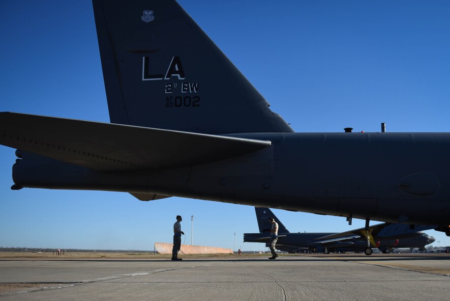 Senior Airman Calvin Kunkel and Airman 1st Class Terell Holmstrom, 2nd Aircraft Maintenance Squadron crew chiefs, preform preflight checks under the tail of a B-52 Stratofortress at Barksdale Air Force Base, La., Jan. 30, 2017. Part of a crew chief’s job is to send the jet up and receive them after they land. (U.S. Air Force photo/Airman 1st Class Stuart Bright)