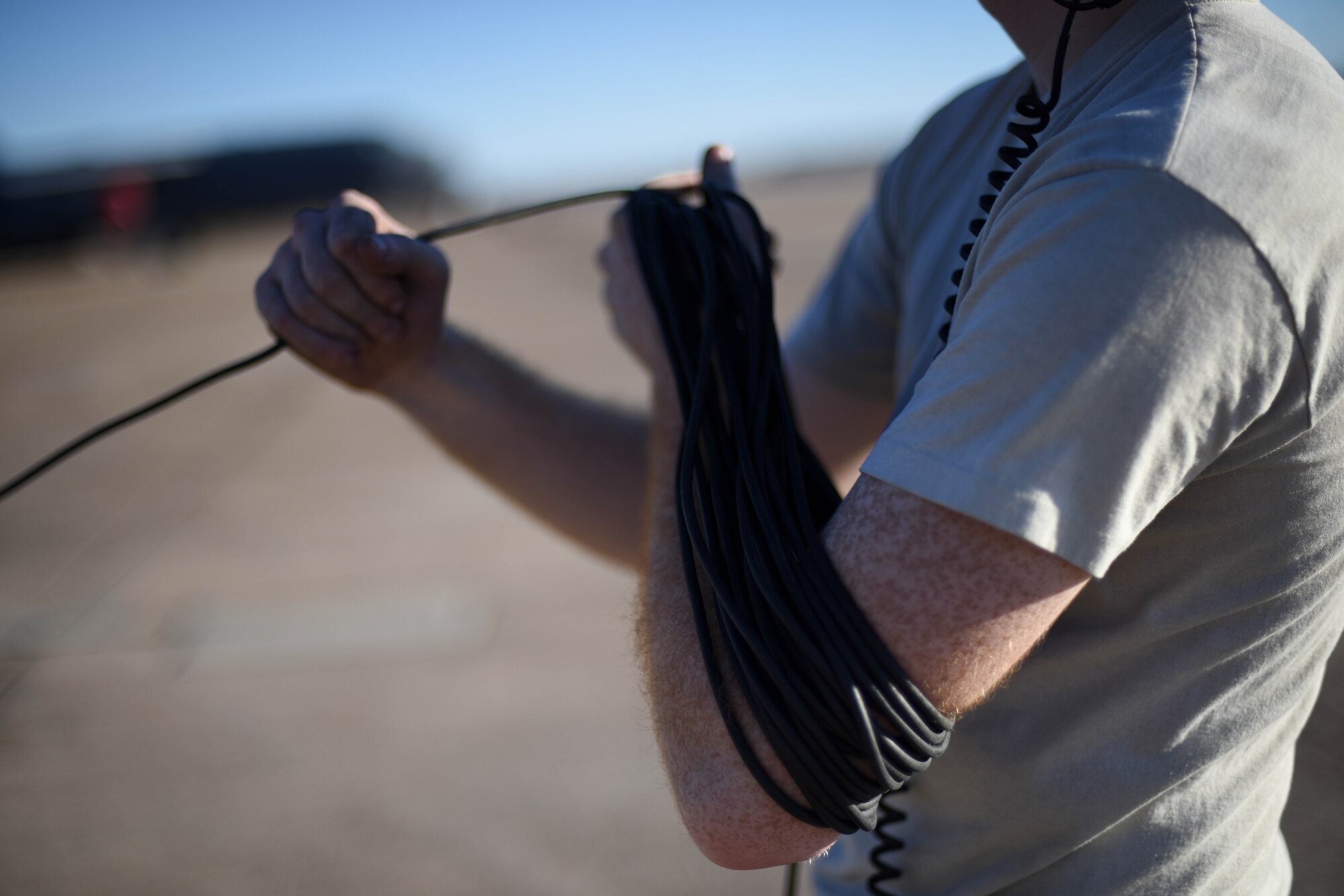 Senior Airman Calvin Kunkel, 2nd Aircraft Maintenance Squadron crew chief, wraps up his headset cord at Barksdale Air Force Base, La., Jan. 30, 2017. The cord allows Kunkel to speak with aircrew inside the jet. (U.S. Air Force photo/Airman 1st Class Stuart Bright)