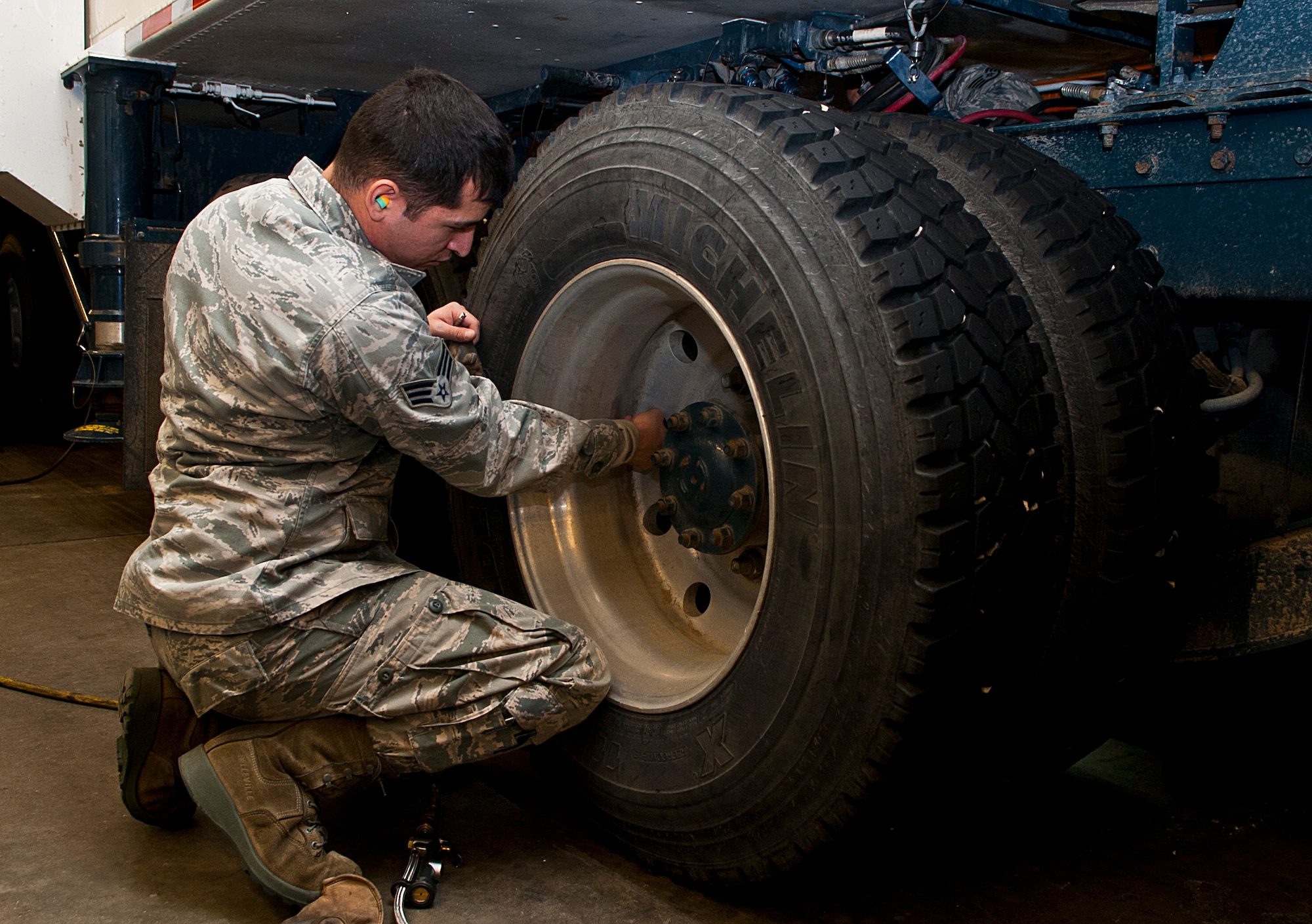 Senior Airman Francisco Perez, 91st Missile Maintenance Squadron missile handling team technician, inspects tire lugs on a transporter erector at Minot Air Force Base, N.D., Jan. 19, 2017. The MHT oversees the shipping and receiving of nuclear capable Minuteman missiles and is responsible for transporting them to-and-from a launch facility. (U.S. Air Force photo/Airman 1st Class Jonathan McElderry)