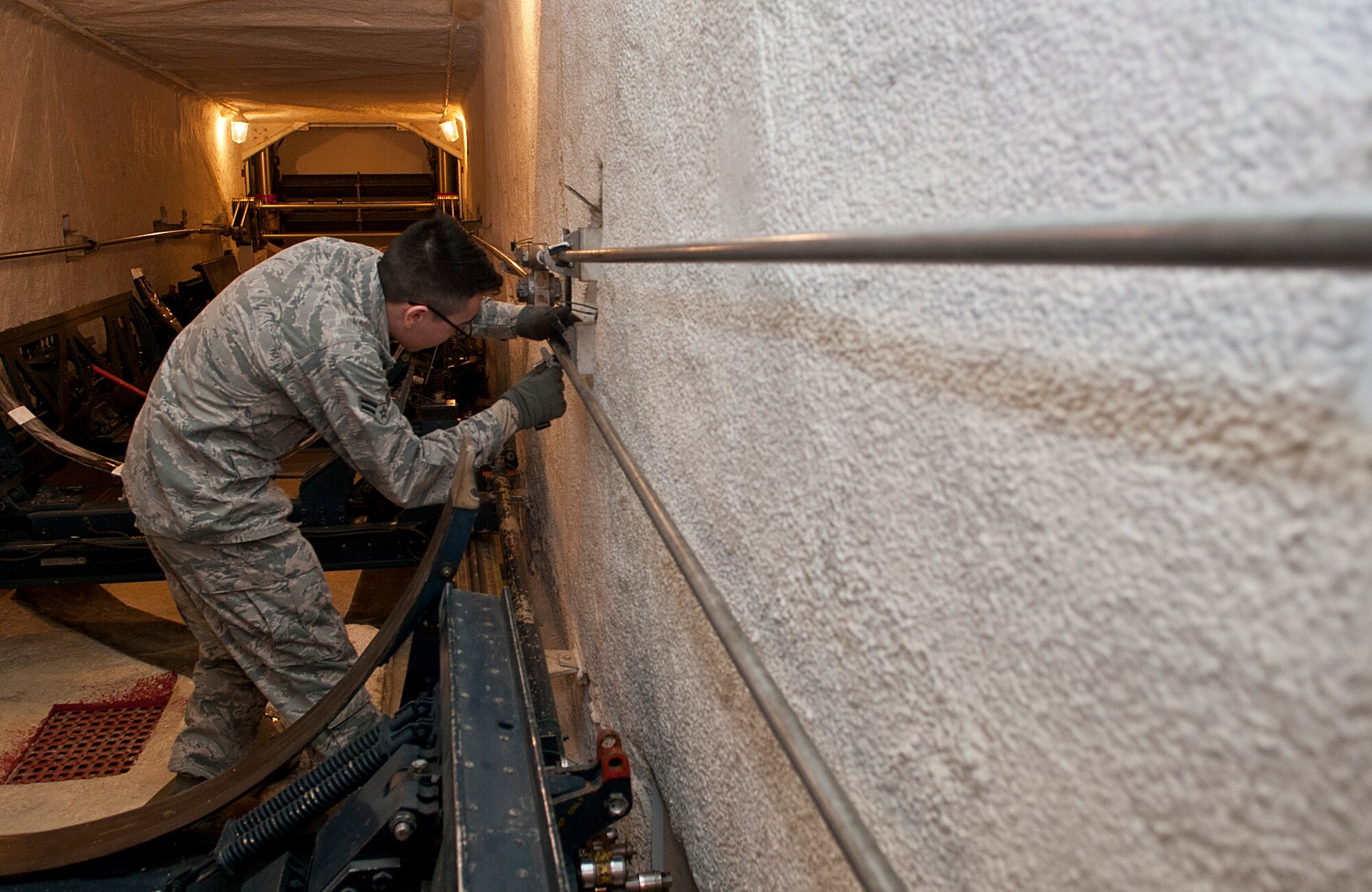 Airman 1st Class Antonio Torres, 91st Missile Maintenance Squadron missile handling team technician, inspects transporter erector sling rods at Minot Air Force Base, N.D., Jan. 19, 2017. When the MHT is at a launch facility, they are directly involved in the installation or removal of the nuclear capable Minuteman III missile's booster stages. (U.S. Air Force photo/Airman 1st Class Jonathan McElderry)