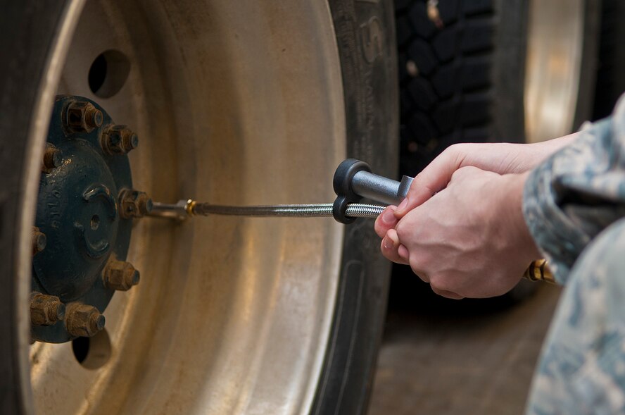 An Airman with the 91st Missile Maintenance Squadron missile handling team inflates a tire on a transporter erector at Minot Air Force Base, N.D., Jan. 19, 2017. The MHT must ensure the tires are at least 90 psi when performing a pre-operations inspection. (U.S. Air Force photo/Airman 1st Class Jonathan McElderry)