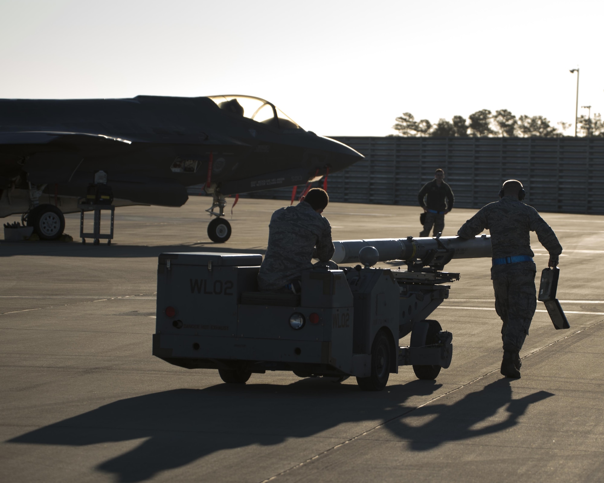 A U.S. Air Force weapons load crew assigned to the 33rd Aircraft Maintenance Squadron transports a live AIM-120 advanced medium-range air-to-air missiles (AMRAAM) before loading it into an F-35A January 31, 2017, at Eglin Air Force Base, Florida. The 33rd Fighter Wing loaded and shot the first air-to-air missiles from an F-35A during a weapons system evaluation that took place at Tyndall Air Force Base later the same day. Carrying air-to-air missiles makes the F-35 a more versatile option for combatant commanders by securing the aircrafts survivability, in turn increasing likeliness of mission success. (U.S. Air Force photo by Staff Sgt. Peter Thompson)