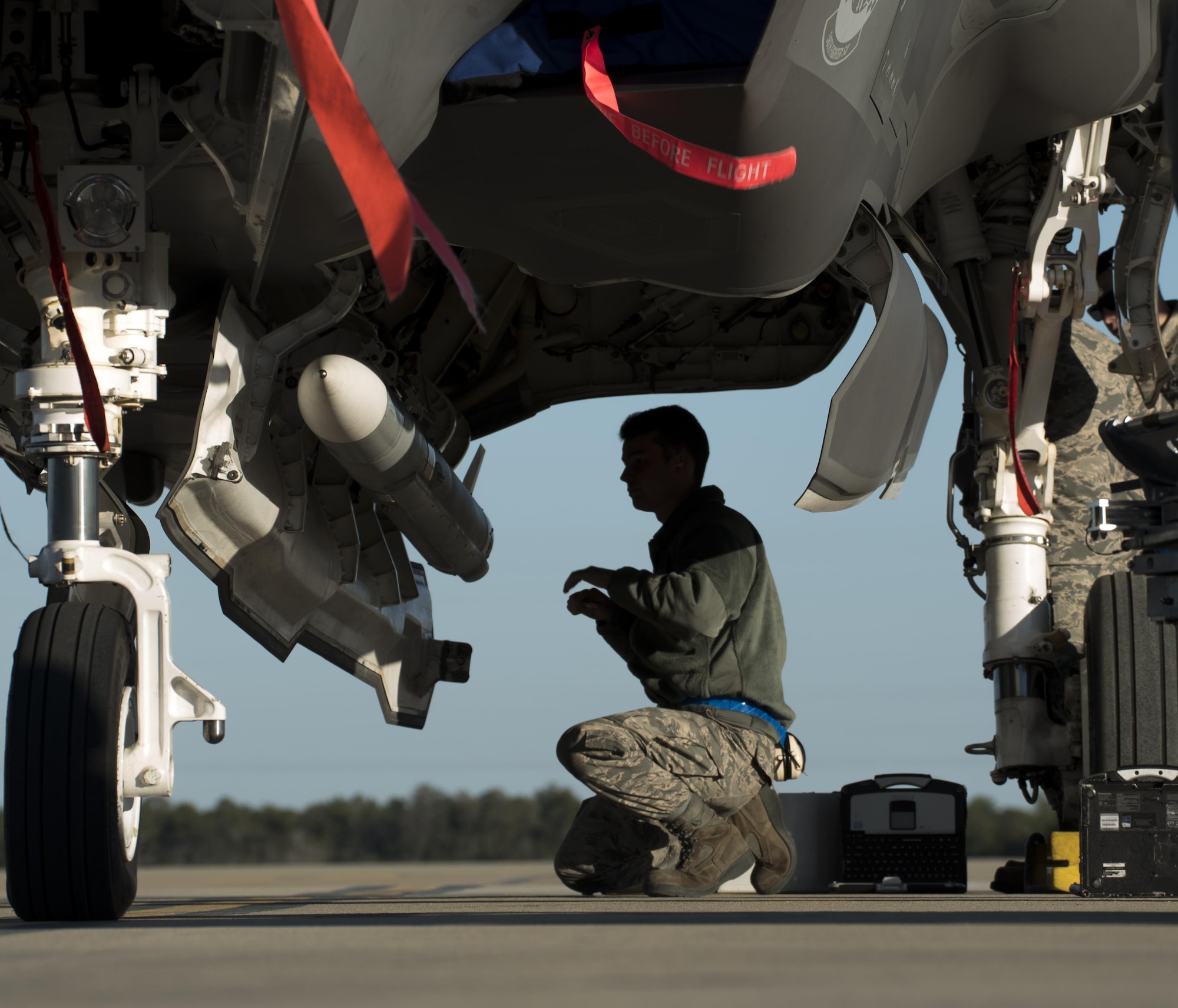 U.S. Air Force Airman 1st Class Dylan Snead, 33rd Aircraft Maintenance Squadron weapons load crew member, secures a live AIM-120 advanced medium-range air-to-air missiles (AMRAAM)  onto a weapons jammer before loading it into an F-35A January 31, 2017, at Eglin Air Force Base, Florida. The 33rd Fighter Wing loaded and shot the first air-to-air missiles from an F-35A during a weapons system evaluation that took place at Tyndall Air Force Base later the same day. Carrying air-to-air missiles makes the F-35 a more versatile option for combatant commanders by securing the aircrafts survivability, in turn increasing likeliness of mission success.  (U.S. Air Force photo by Staff Sgt. Peter Thompson)