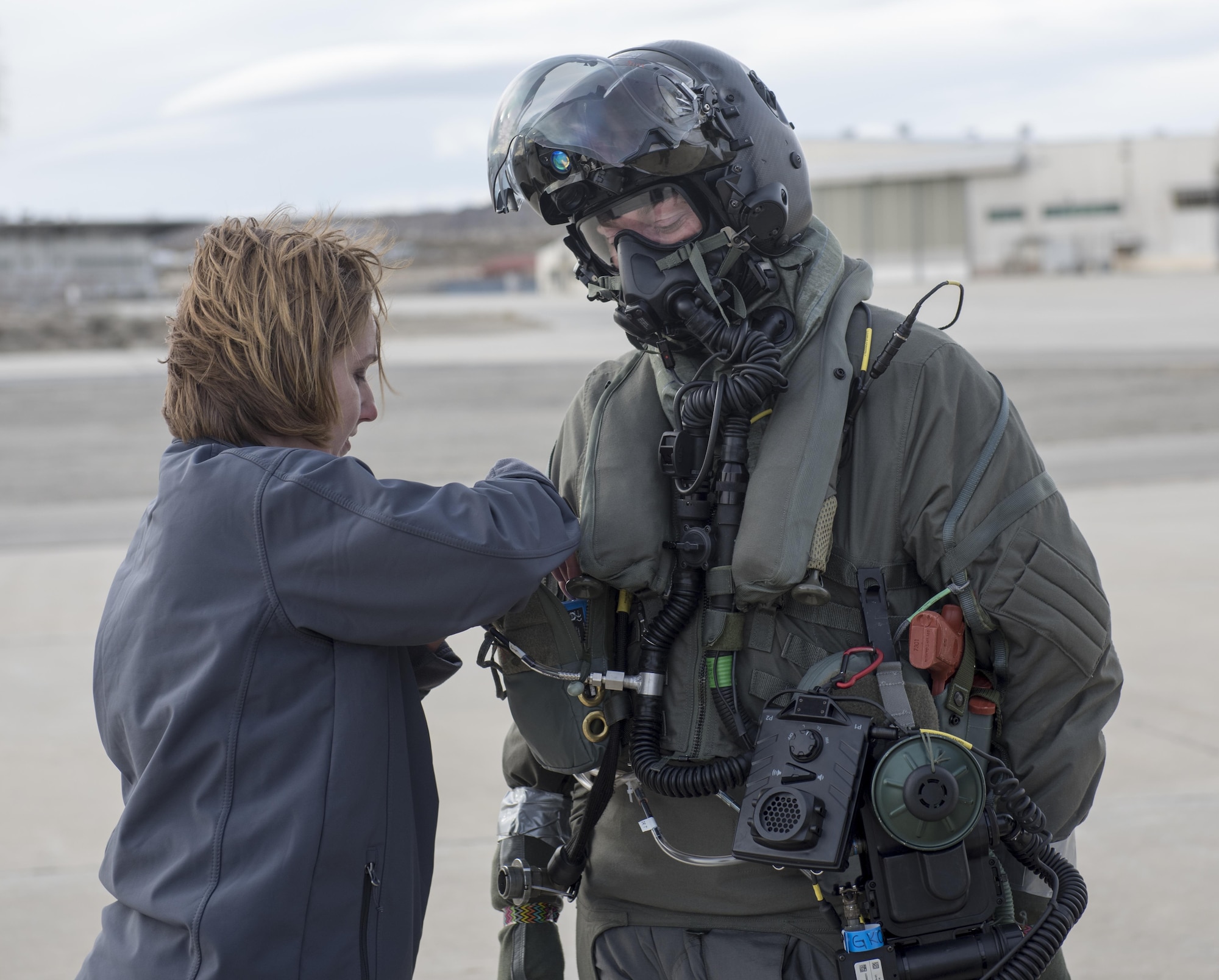 Marine Corps Maj. Douglas Rosenstock, 461st Flight Test Squadron, is inspected by contractor Dr. Angela Theys during a chemical/biological pilot ensemble test Jan. 6. (U.S. Air Force photo by Brad White)