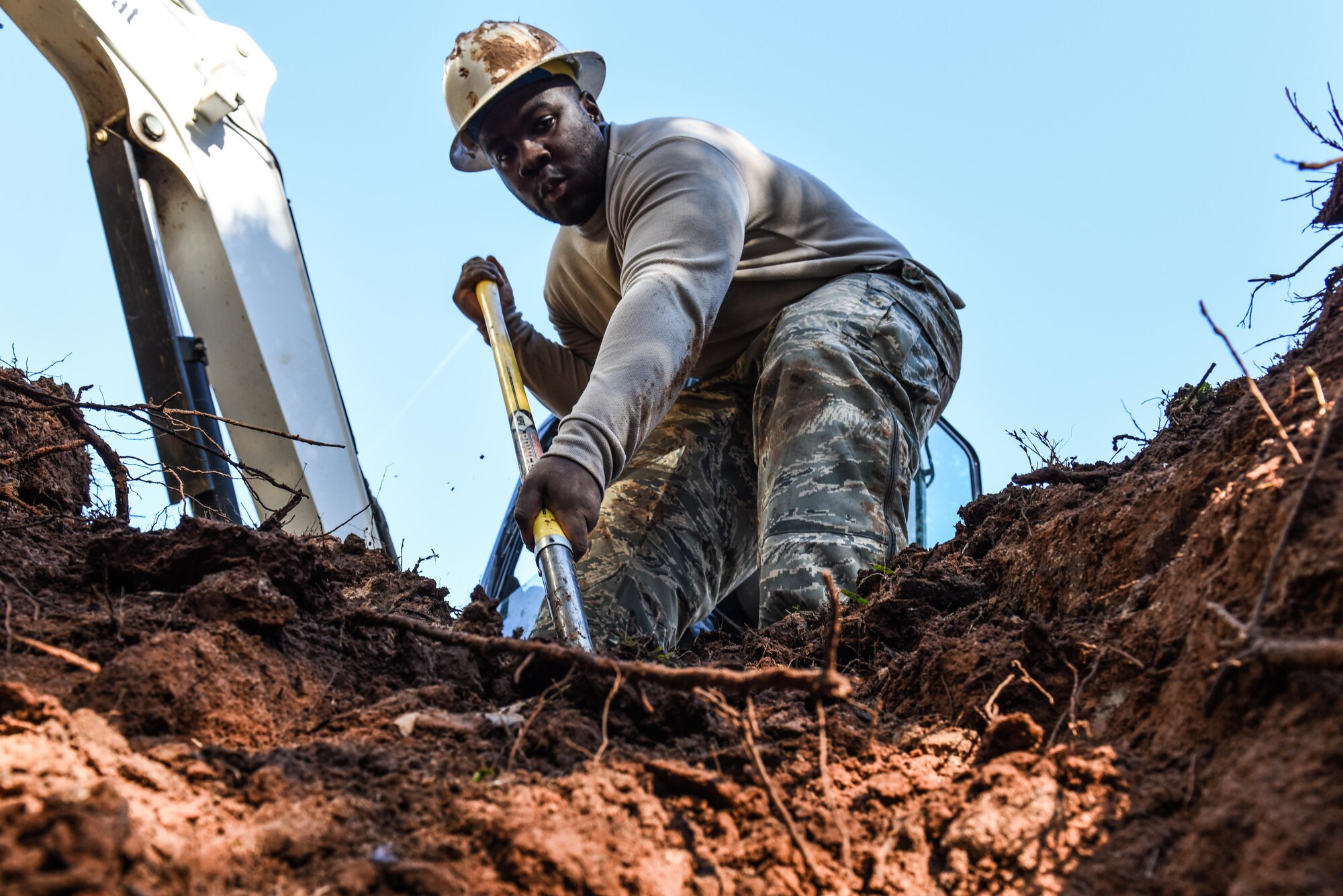 Senior Airman Samuel Parker, left, and Airman 1st Class Ashmiru Sallu-Sam, 2nd Civil Engineer Squadron water and fuel systems Airmen, install a new pipe in the main water line system at Barksdale Air Force Base, La., Jan. 31, 2017. The water line was damaged while contractors were laying fiber optic cable. (U.S. Air Force photo/Senior Airman Luke Hill)