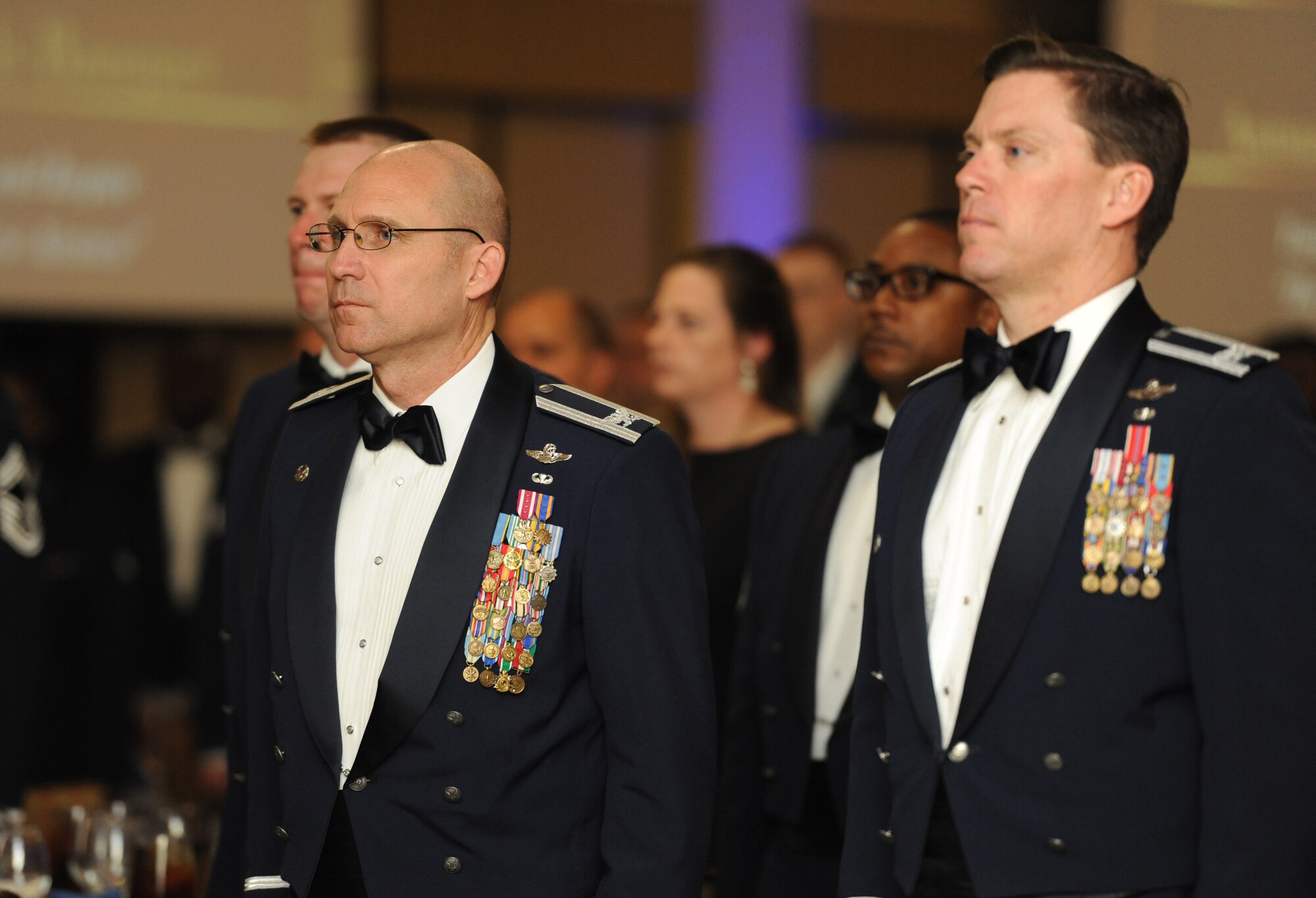 (Left) Col. Michael Manion, 403rd Wing commander, and Col. C. Mike Smith, 81st Training Wing vice commander, stand at attention during the 2016 Keesler Annual Awards Ceremony at the Bay Breeze Event Center Jan. 31, 2017, on Keesler Air Force Base, Miss. During the ceremony base leadership recognized outstanding Airmen and civilians from across the installation for their accomplishments throughout 2016. (U.S. Air Force photo by Kemberly Groue)