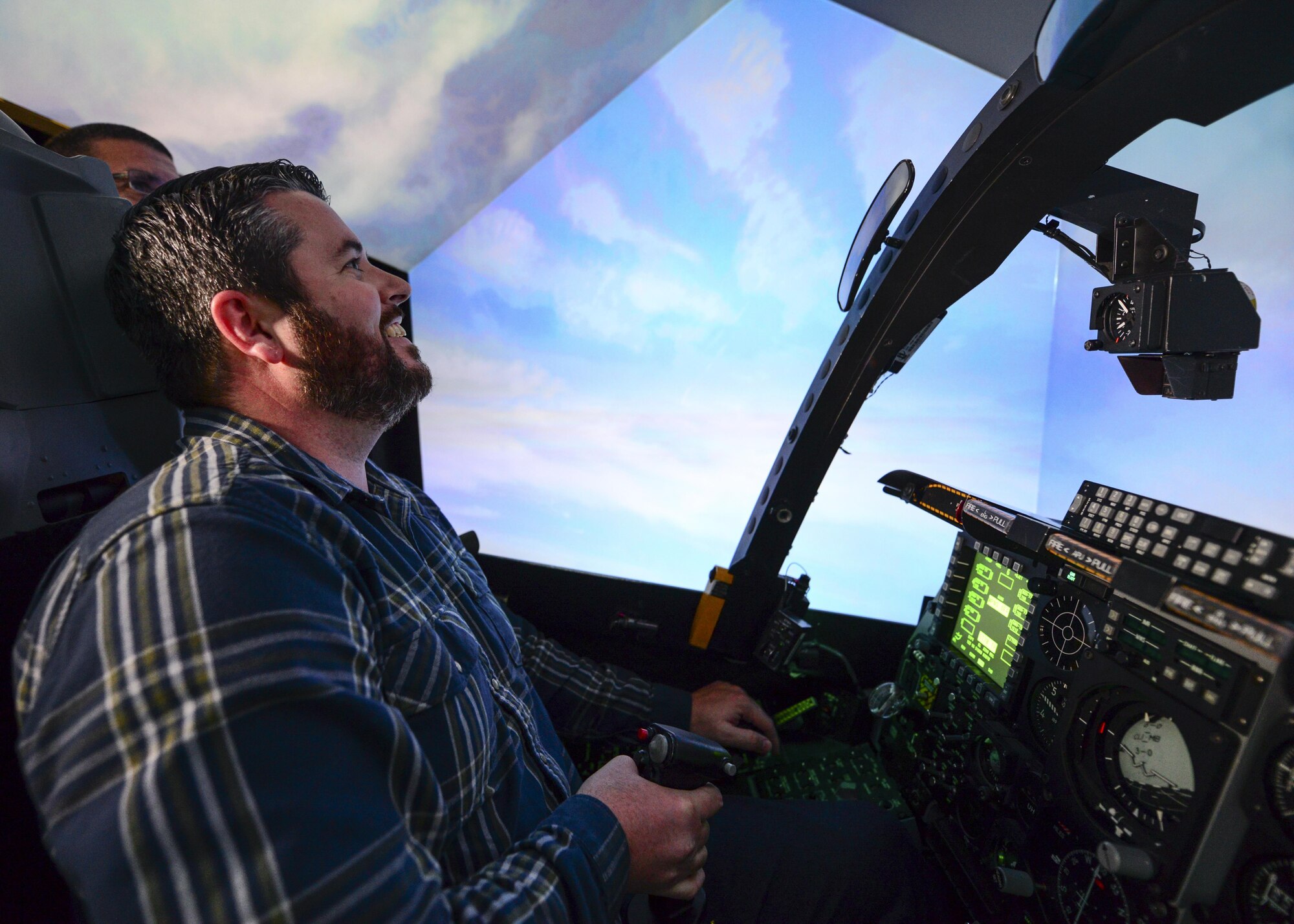 Marcus Foiles pilots an A-10 flight simulator during a tour at Davis-Monthan Air Force Base, Ariz., Jan. 27, 2017. Foiles was 10 years old in 1989 when he was granted a trip to D-M via the Make-A-Wish Foundation after being diagnosed with leukemia. Foiles made the trip back to D-M this past January and was able to pilot a flight simulator that was generations ahead of the one he flew in 1989. (U.S. Air Force photo by Airman 1st Class Nathan H. Barbour)