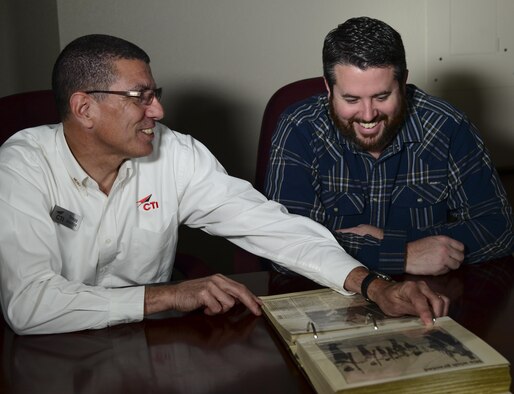 Retired Air Force Lt. Col. Gregg Montijo and Marcus Foiles look over a photo album at Davis-Monthan Air Force Base, Ariz., Jan. 27, 2017. Foiles was 10 years old in 1989 when he was granted a trip to Davis-Monthan AFB via the Make-A-Wish Foundation after being diagnosed with leukemia. Then he made the trip back to Davis-Monthan AFB this past January, bringing with him a photo album made by his mother from the original trip. (U.S. Air Force photo/Airman 1st Class Nathan H. Barbour)