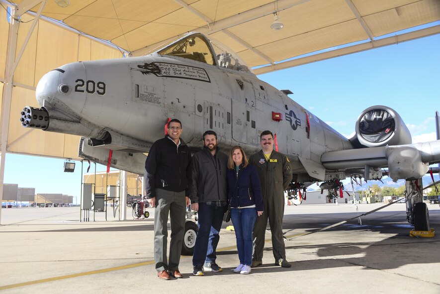 (From left to right) Retired Air Force Lt. Col. Gregg Montijo, Marcus Foiles, his wife Melanie, and 1st Lt. Christopher McBride, a 355th Training Squadron A-10 pilot, pose for a photo on the flight line at Davis-Monthan Air Force Base, Ariz., Jan. 27, 2017. Foiles was 10 years old in 1989 when he was granted a trip to Davis-Monthan AFB via the Make-A-Wish Foundation after being diagnosed with leukemia. Foiles made the trip back to Davis-Monthan AFB to reconnect with Montijo, the pilot who hosted the tour 28 years ago. (U.S. Air Force photo/Airman 1st Class Nathan H. Barbour)