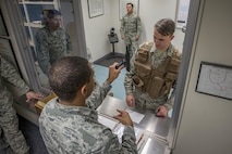 Airmen with the 374th Operations Support Squadron Aircrew Flight Equipment Flight practice issuing weapons to aircrew during a weapons training exercise Jan. 20, 2017 at Yokota Air Base, Japan. The AFE flight is responsible for the aircrew armory, and conducts regular training and certification on various weapons. (U.S. Air Force photo by Airman 1st Class Donald Hudson)