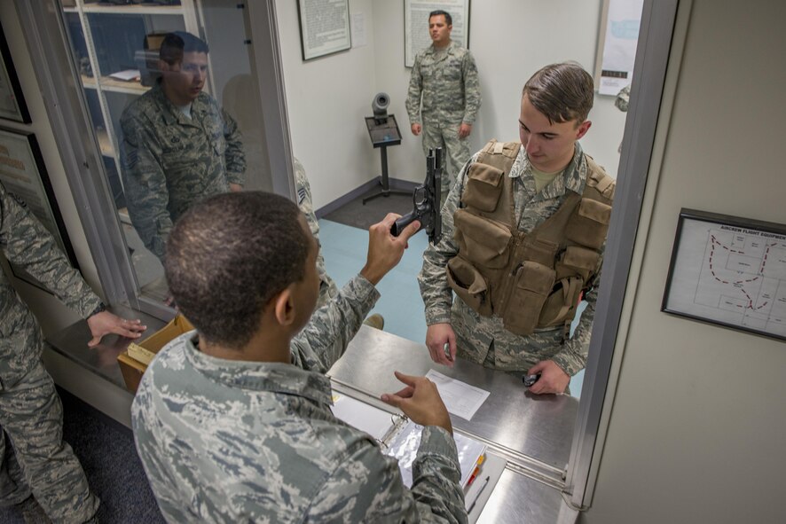 Airmen with the 374th Operations Support Squadron Aircrew Flight Equipment Flight practice issuing weapons to aircrew during a weapons training exercise Jan. 20, 2017 at Yokota Air Base, Japan. The AFE flight is responsible for the aircrew armory, and conducts regular training and certification on various weapons. (U.S. Air Force photo by Airman 1st Class Donald Hudson)