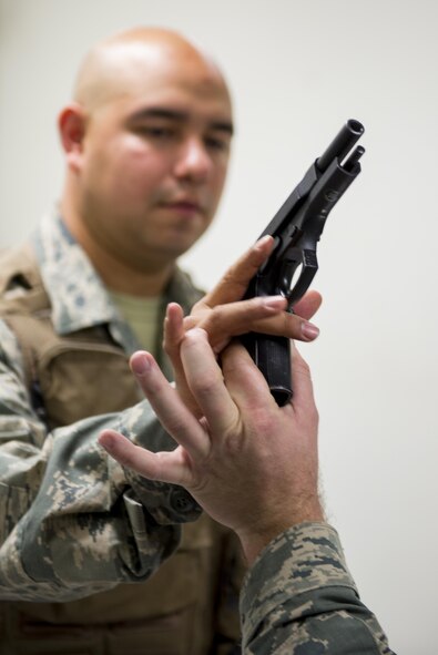 Airmen with the 374th Operations Support Squadron Aircrew Flight Equipment Flight handle weapons during a weapons training exercise Jan. 20, 2017 at Yokota Air Base, Japan. The AFE flight is responsible for the aircrew armory, and conducts regular training and certification on various weapons. (U.S. Air Force photo by Airman 1st Class Donald Hudson)