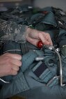 Tech. Sgt. Rachel R. Atchley, 374th Operations Support Squadron Aircrew Flight Equipment Flight quality assurance program manager, performs a final equipment check on a back automatic parachute before it is placed for use on a C-130H Hercules Jan. 20, 2017 at Yokota Air Base, Japan. The AFE flight is responsible for the repair, packing, and all-around maintenance of parachutes used by aircrew and survival, evasion, resistance and escape specialists. (U.S. Air Force photo by Airman 1st Class Donald Hudson)