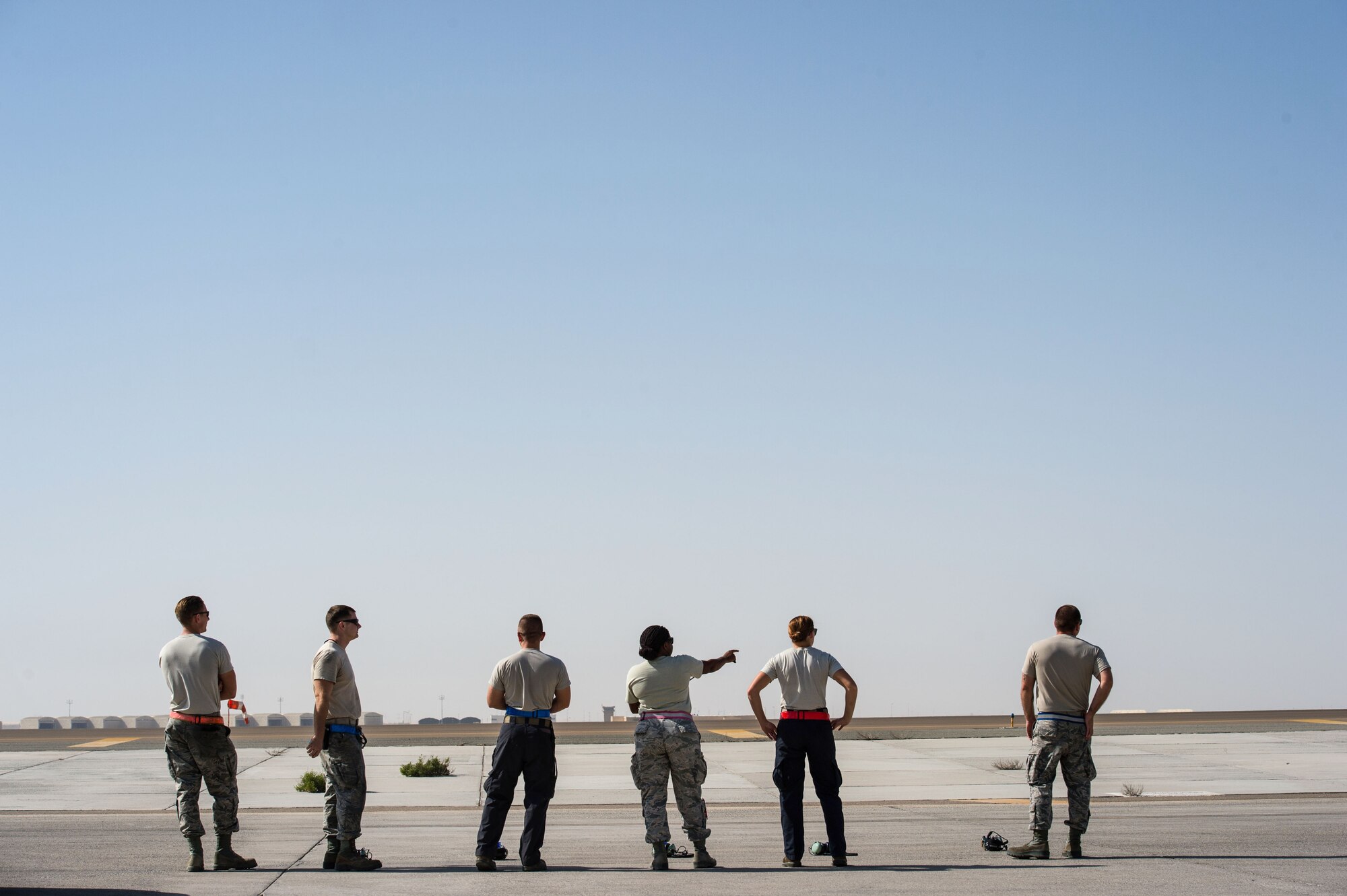 380th Expeditionary Aircraft Maintenance Squadron Airmen watch an E-3 Sentry before it departs and completes a sortie in support of Combined Joint Task Force-Operation Inherent Resolve at an undisclosed location in Southwest Asia, Feb. 2, 2017. After every preflight inspection, the E-3 Sentry maintainers complete as many push-ups as possible while the aircraft takes off. (U.S. Air Force photo by Senior Airman Tyler Woodward)
