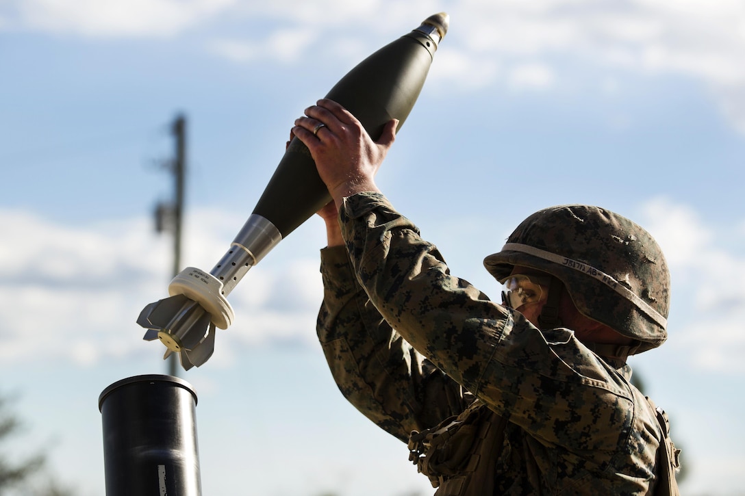 A Marine prepares to load round into the tube of an M121 A1 120 mm mortar system during live-fire training at Camp Lejeune, N.C., Jan. 24, 2017. Marine Corps photo by Sgt. Justin T. Updegraff
