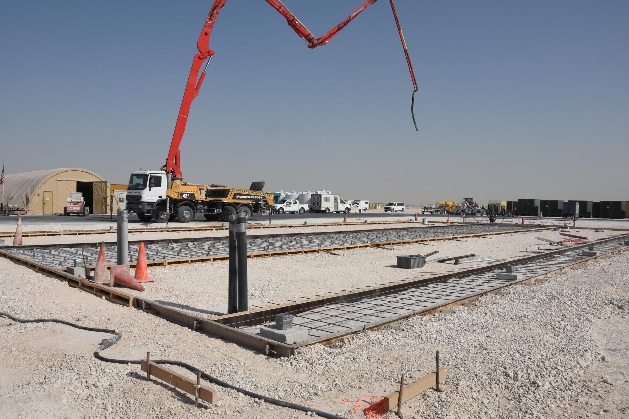 A construction site waits as Airmen with the 557th Expeditionary RED HORSE Squadron prepare to lay cement at Al Udeid Air Base, Qatar, Jan. 31, 2017. Airmen with 557th ERHS are currently constructing two facilities at the close air support ramp to support administration, operators, and supply functions for all aircraft maintenance units there. (U.S. Air Force photo by Senior Airman Cynthia A. Innocenti)