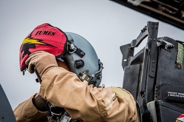 U. S. Air Force Col. David Brynteson, 332nd Expeditionary Operations Group commander, dons his helmet Jan. 27, 2017, in Southwest Asia. Brynteson was preparing to fly his last sortie in theater. (U.S. Air Force photo by Staff Sgt. Eboni Reams)