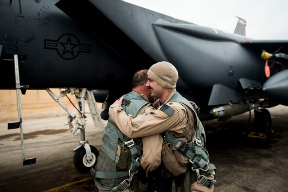 U. S. Air Force Col. David Brynteson, 332nd Expeditionary Operations Group commander, embraces his crewmate, after his fini flight, Jan. 27, 2017, in Southwest Asia. Brynteson has been commanding here for four months leading combat operations in the area of responsibility. (U.S. Air Force photo by Staff Sgt. Eboni Reams)