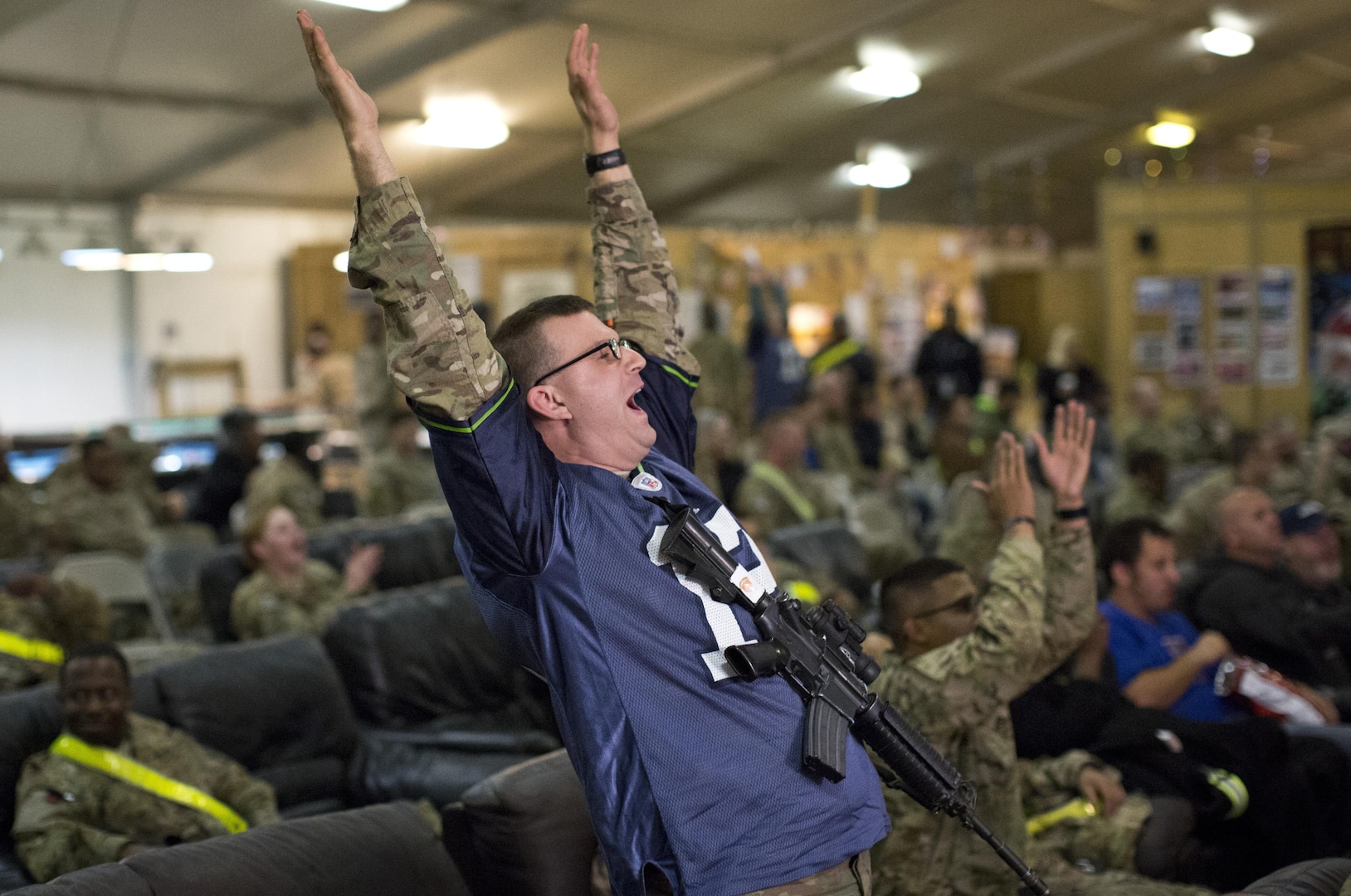 Capt. Joe Beale, a systems automation officer assigned to the 57th Expeditionary Signal Battalion and deployed to Kandahar Airfield, Afghanistan, cheers as the Seattle Seahawks score a touchdown during Super Bowl XLVIII, Feb. 2, 2014. DLA Troop Support’s Subsistence supply chain helped ensure service members enjoy traditional fare for this year’s big game.