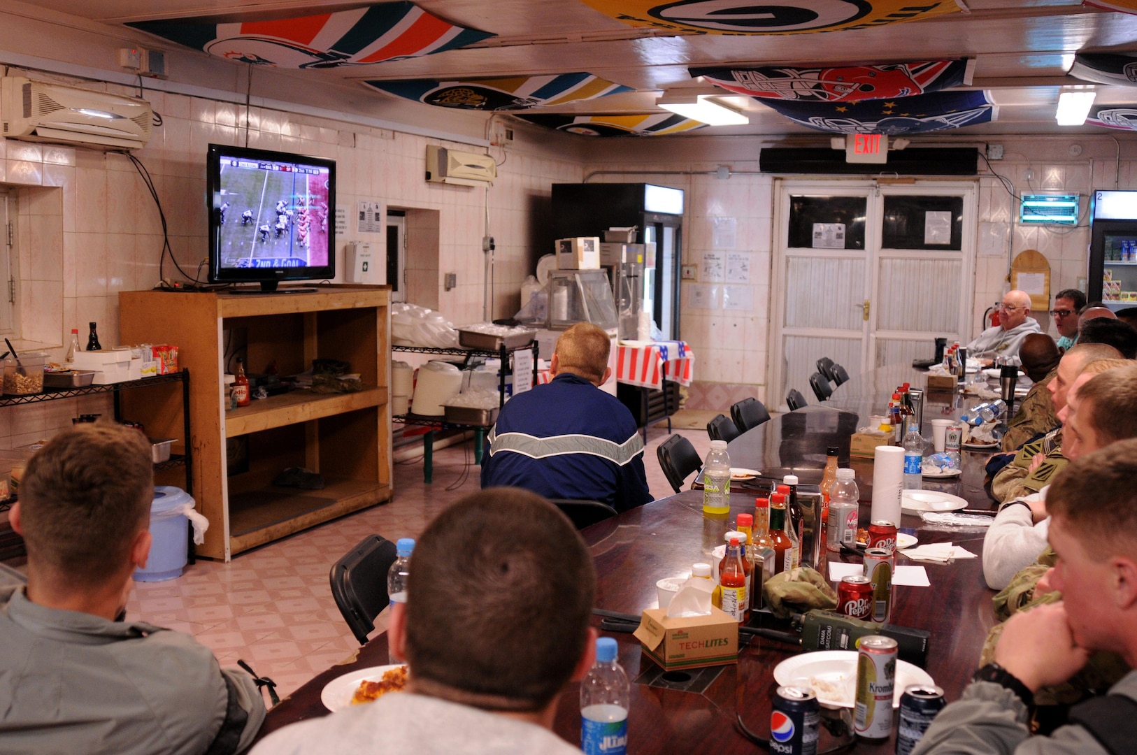 Members of Zabul Provincial Reconstruction Team watch Super Bowl XLVII at Forward Operating Base Smart, Afghanistan, Feb. 4, 2013. DLA Troop Support’s Subsistence supply chain helped ensure service members enjoy traditional fare for this year’s big game.