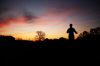 The sun rises as the 2nd Marine Division commanding officer, Maj. Gen. John K. Love, speaks to the division Marines with words of encouragement and motivation at the 2nd MarDiv 50 mile hike at Camp Lejeune, N.C., Feb. 1, 2017. After the hike's opening ceremony, the Marines gathered at the starting point, ready to set off. The hike originated in 1908 with an executive order administered by then president Theodore Roosevelt and has since then only been attempted and completed twice since its inception.