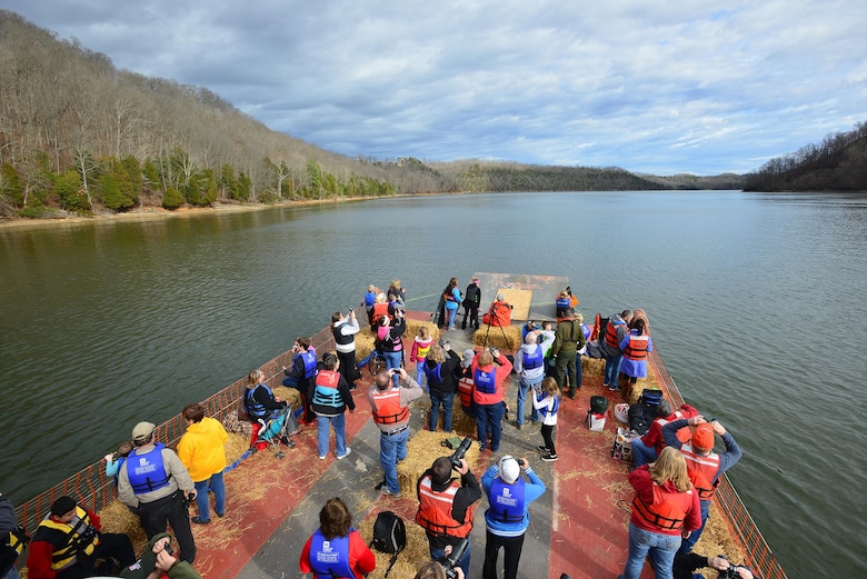 Eager sightseers boarded a U.S. Army Corps of Engineers open barge today to explore for American Bald Eagles along the Dale Hollow Lake shoreline. They stared at the tree tops on the horizon for a glimpse of America’s symbol of freedom and learned about how these amazing birds made a comeback to the region in the 1980s.