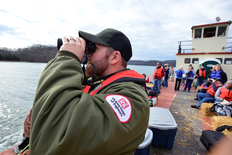 Park Ranger Brad Potts uses binoculars to scan the skies for eagles onboard the barge Jan. 21, 2017 at Dale Hollow Lake. 