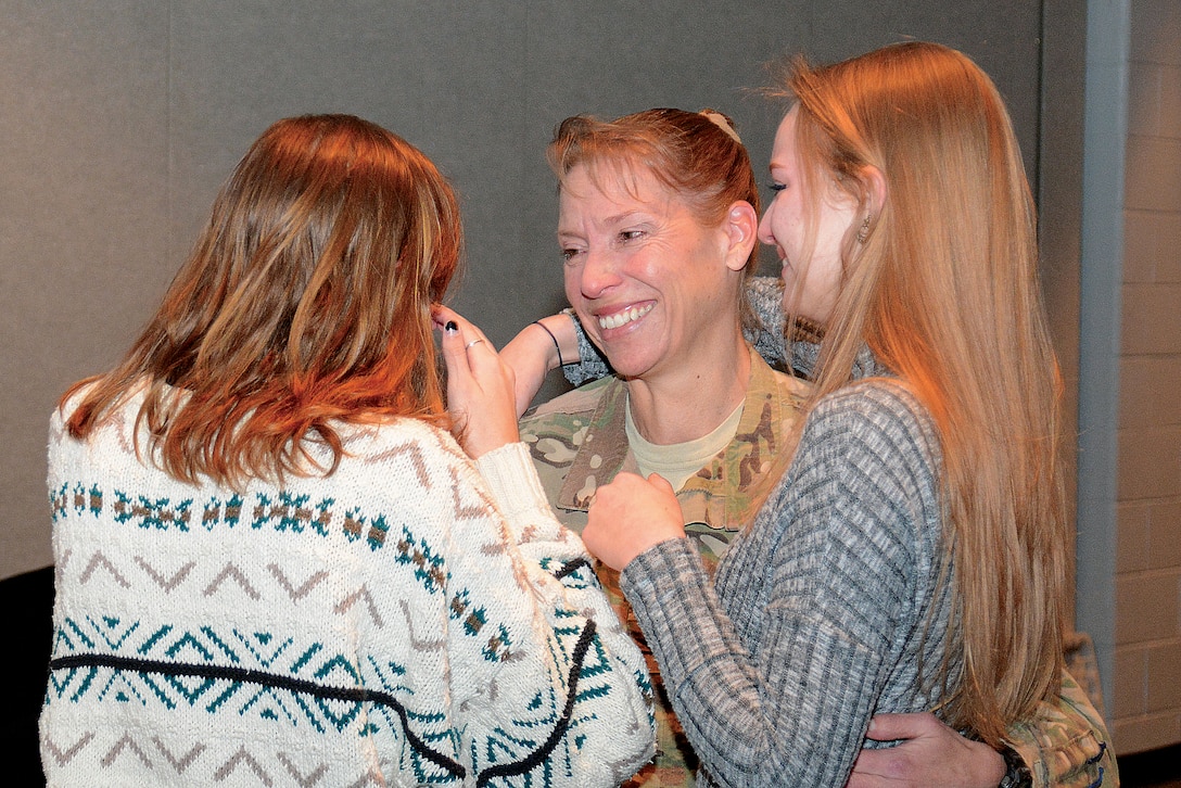 Army Col. Beth Prekker greets her daughters, Lindsay and Caroline, during her surprise return from Iraq at Cosby High School in Midlothian, Va., Jan. 5, 2016. Army photo by Lesley Atkinson