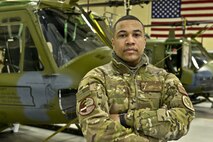Staff Sgt. De'Mario Greene, 54th Helicopter Squadron special missions aviator, poses in the helicopter hangar at Minot Air Force Base, N.D., Jan. 12, 2017. (U.S. Air Force photo/Airman 1st Class Jessica Weissman)