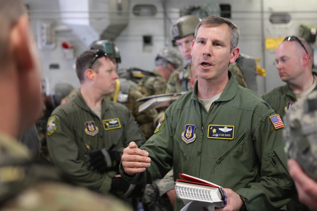 Air Force Lt. Col. Stan Davis, middle, gives a safety briefing to paratroopers before participating in a mass tactical airborne jump during Operation Anvil refresher training at North Air Force Auxiliary Base, S.C., Jan. 26, 2017. Davis is assigned to 317th Airlift Squadron. Army photo by Spc. Christopher Martin