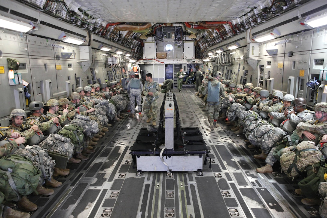 Paratroopers sit inside an Air Force C-17 Globemaster aircraft before participating in a mass tactical airborne jump during Operation Anvil refresher training at North Air Force Auxiliary Base, S.C., Jan. 26, 2017. Army photo by Spc. Christopher Martin